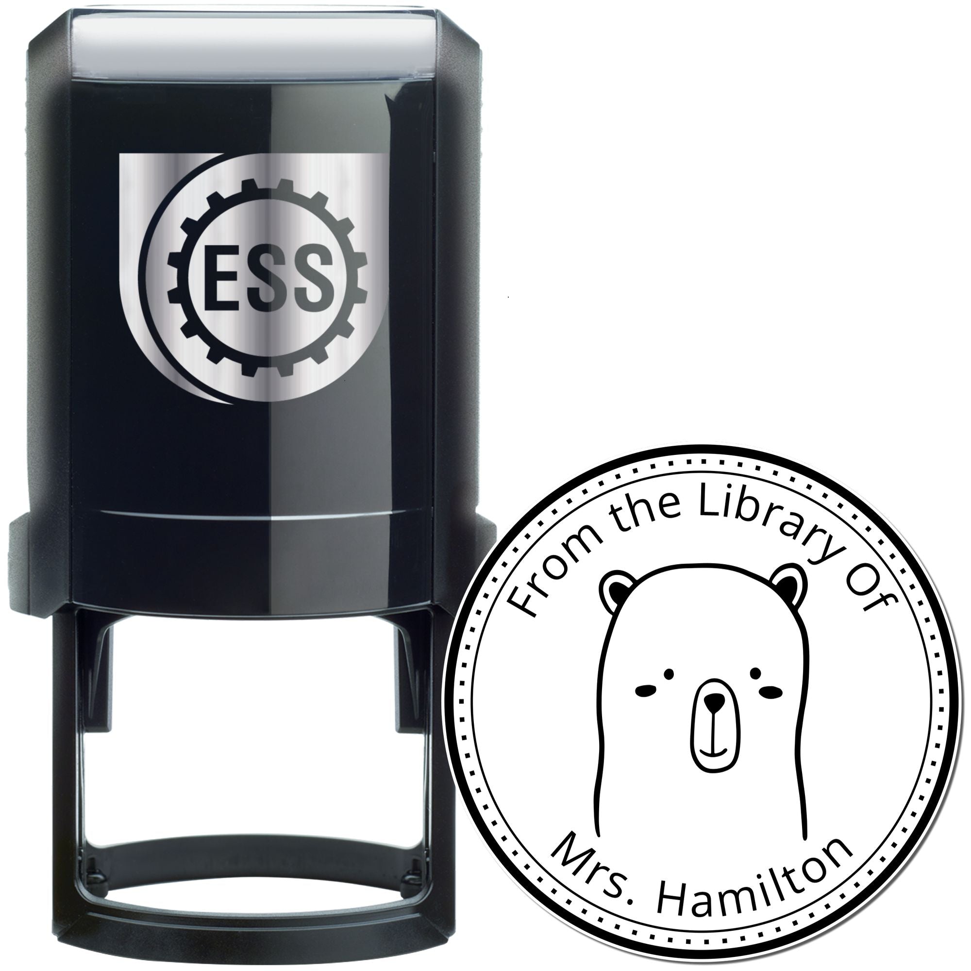 Image of a black self-inking stamp featuring a WhiskerTwist cartoon animal design. The stamp is custom-made for a book library, with text "From the Library Of Mrs. Hamilton." It also serves as a customizable return mail stamp.