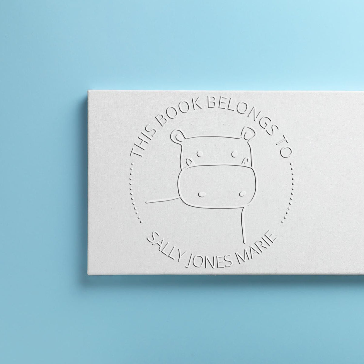 TizzyTwitch Cartoon Animal Hybrid Customized Name For Books Seal displayed on a light blue background. The seal features a cartoon animal design and the text "This Book Belongs To Sally Jones Marie." Ideal for a Personalizable Address Stamp.