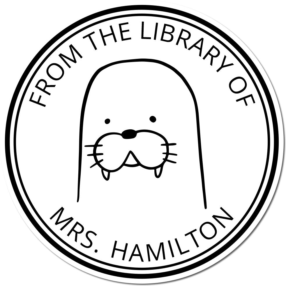 Round stamp with a cartoon animal resembling a walrus, labeled From the Library of Mrs. Hamilton. Features a wood handle BumbleBristle design, suitable as a customized book ownership stamp or personalizable mailing stamp.