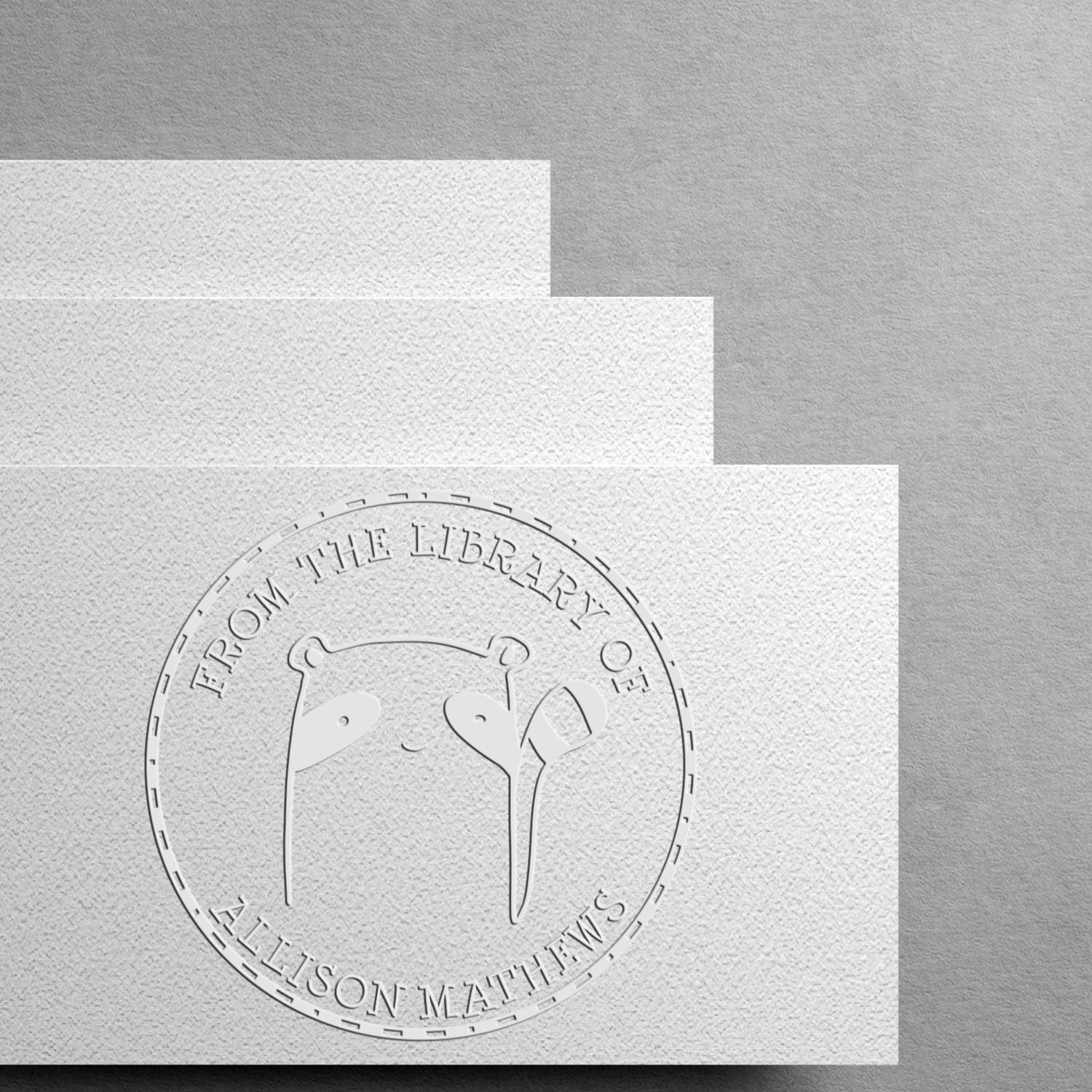 Image of a Customized Address Stamper featuring a FreckleFlop Cartoon Animal Hybrid design embossed on white paper. The text reads "From The Private Library Of" with a name placeholder, showcasing a unique and personalized touch.