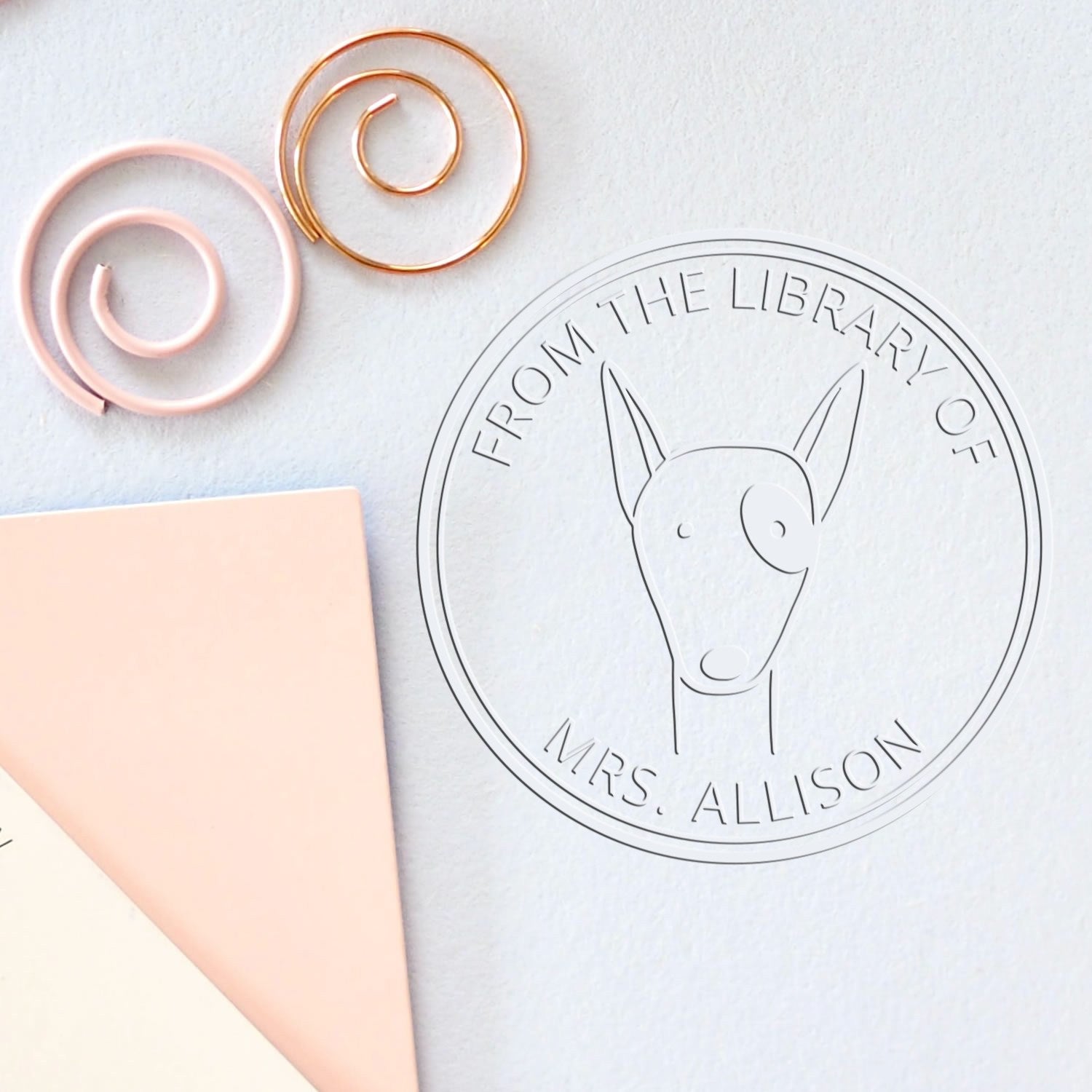 RuffleRump cartoon animal embossing seal on paper, featuring a custom stamp design with a whimsical animal illustration. Ideal for book lovers, this personalized gift adds a unique touch to any library.