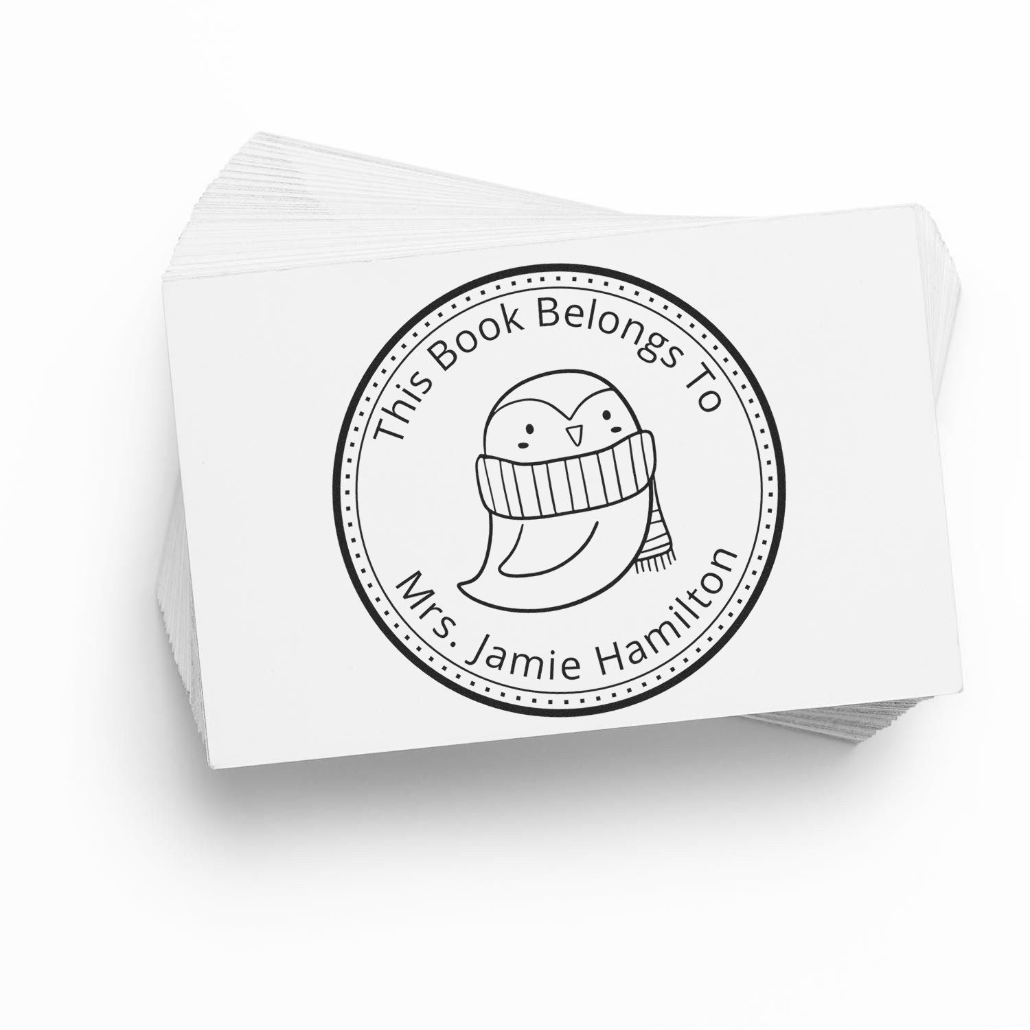 Wood handle QuirkyQuack cartoon animal customized bookplate design stamp featuring a cute bird with a scarf. The stamp is used on a stack of cards, showcasing a customizable return mail stamper design with the text "This Book Belongs To Mrs. Jamie Hamilton."