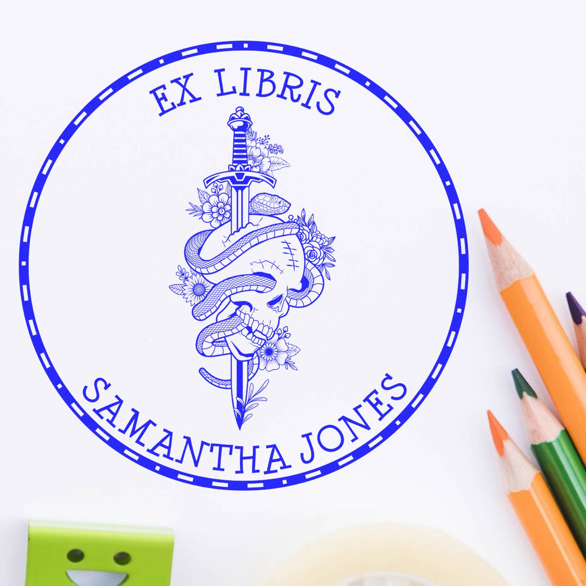 Blue EX LIBRIS custom stamp seal with skull, sword, snakes and flowers, personalized for Samantha Jones, on white paper with colored pencils.