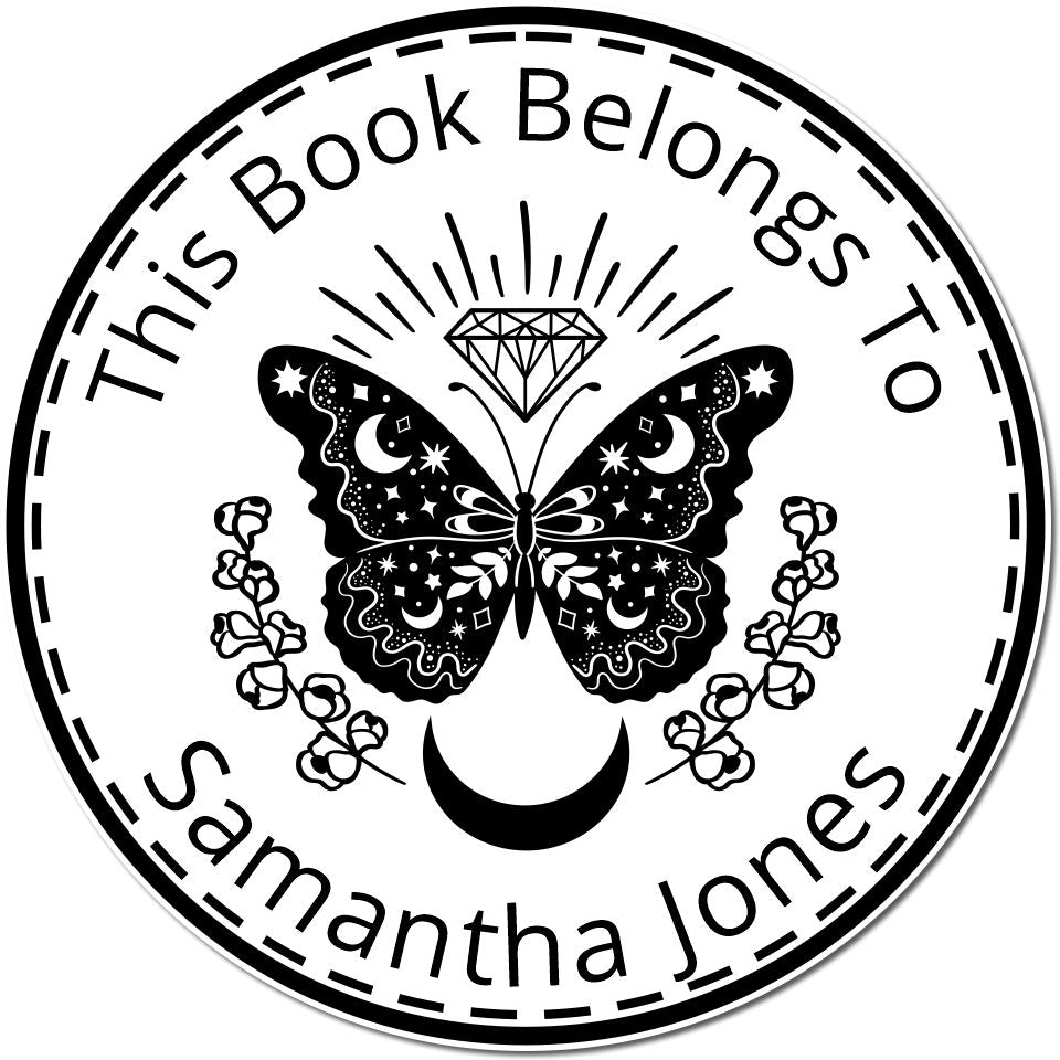 Black circular self-inking stamp seal with butterfly, diamond, crescent moon, and text This Book Belongs To Samantha Jones.