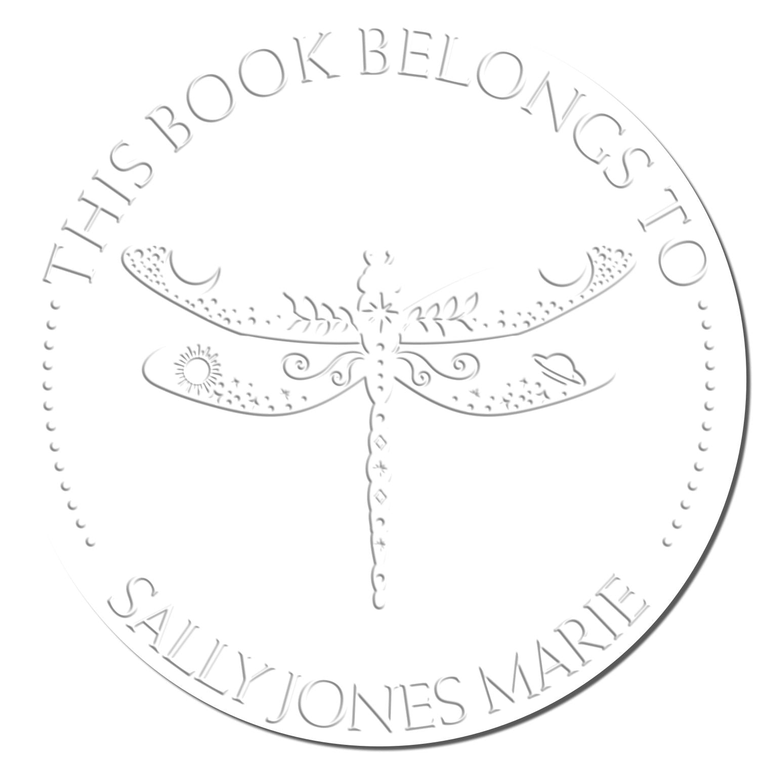 White embossed circular book ownership seal with dragonfly and silver-gray text: “This Book Belongs to Sally Jones Marie.”