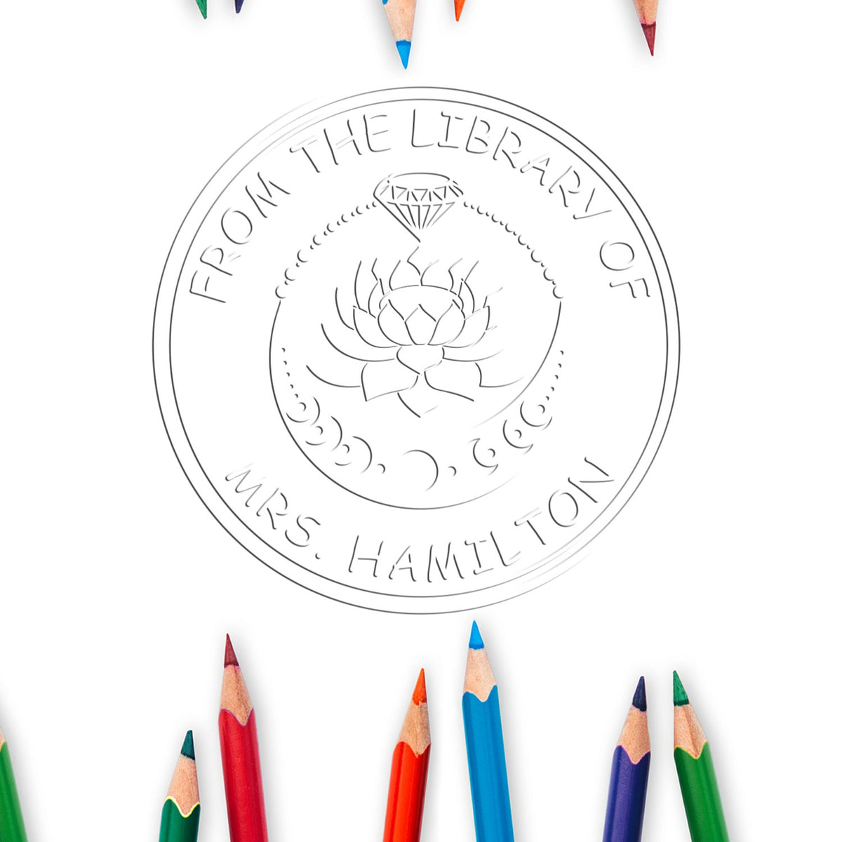 Round library seal stamp with lotus and diamond design, surrounded by colorful pencil tips on white.