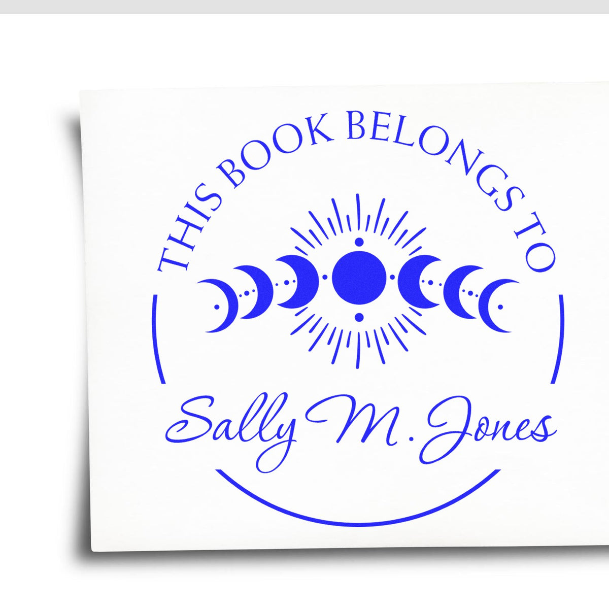 Blue custom book stamp and seal for Sally M. Jones with moon phases, sunburst design, and circular text.