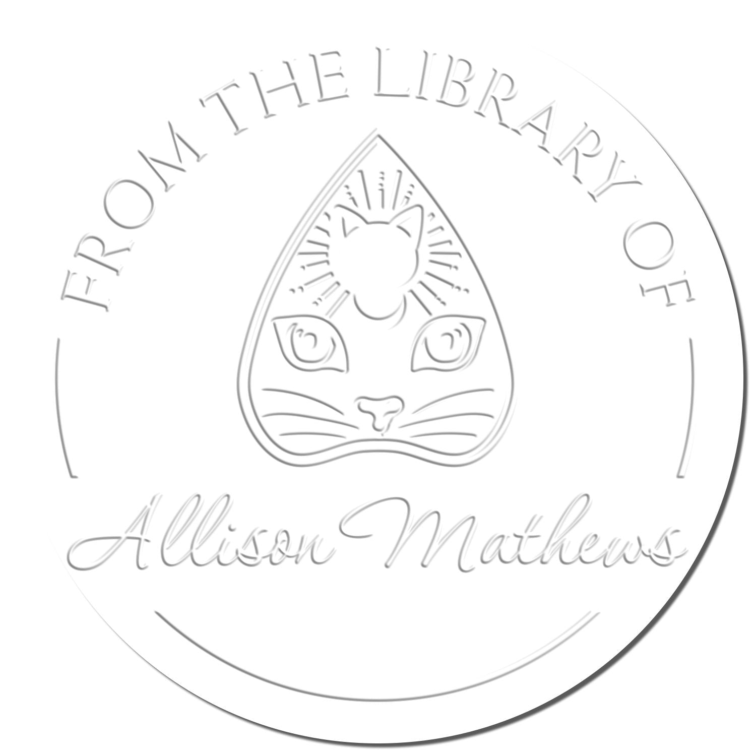 Round white embossed library stamp seal with cat face emblem and silver-gray text From the Library of Allison Mathews