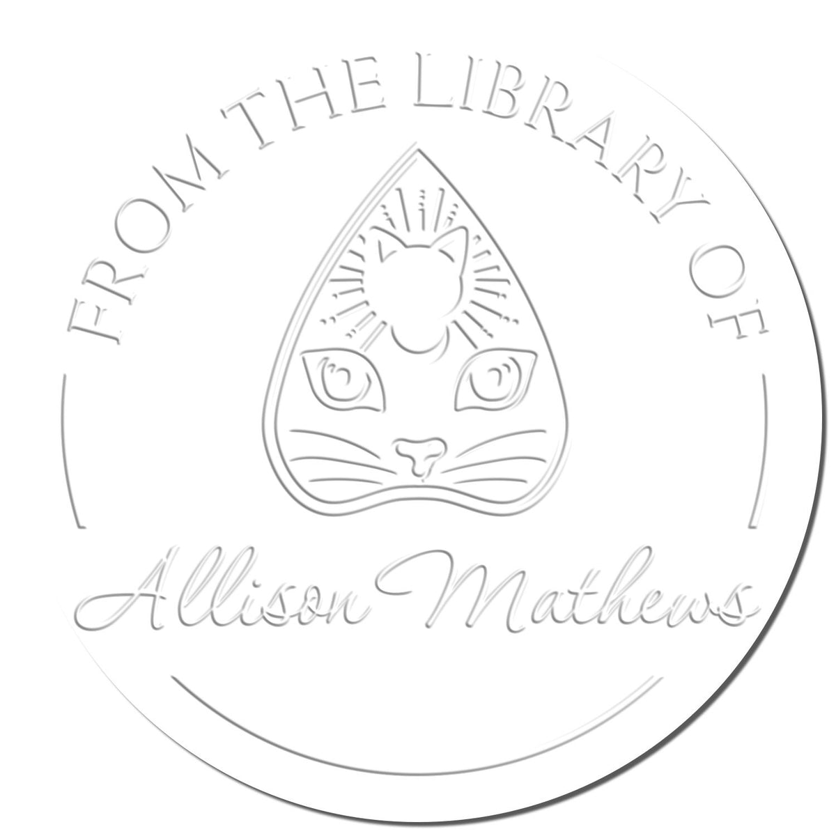 White circular embossed library stamp seal with cat face and From the Library of Allison Mathews text.