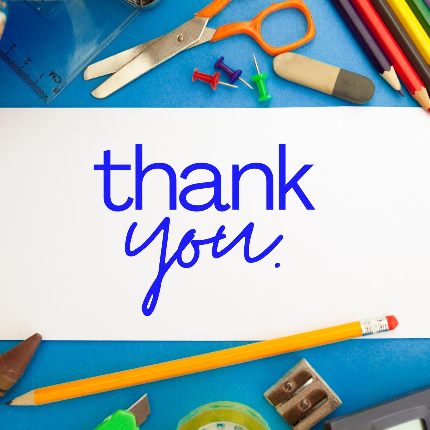 Blue thank-you stamp-and-seal card surrounded by school supplies, with pencils, scissors, ruler, and push pins.