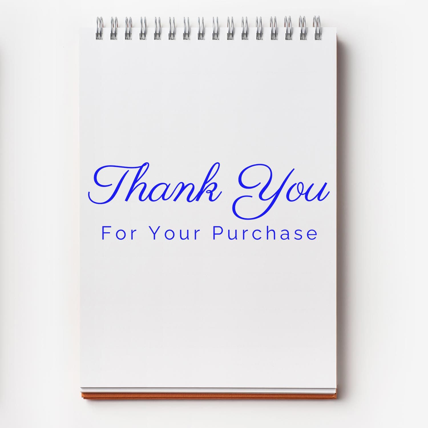 White spiral notebook with silver binding and blue Thank You For Your Purchase text for stamp and seal products.