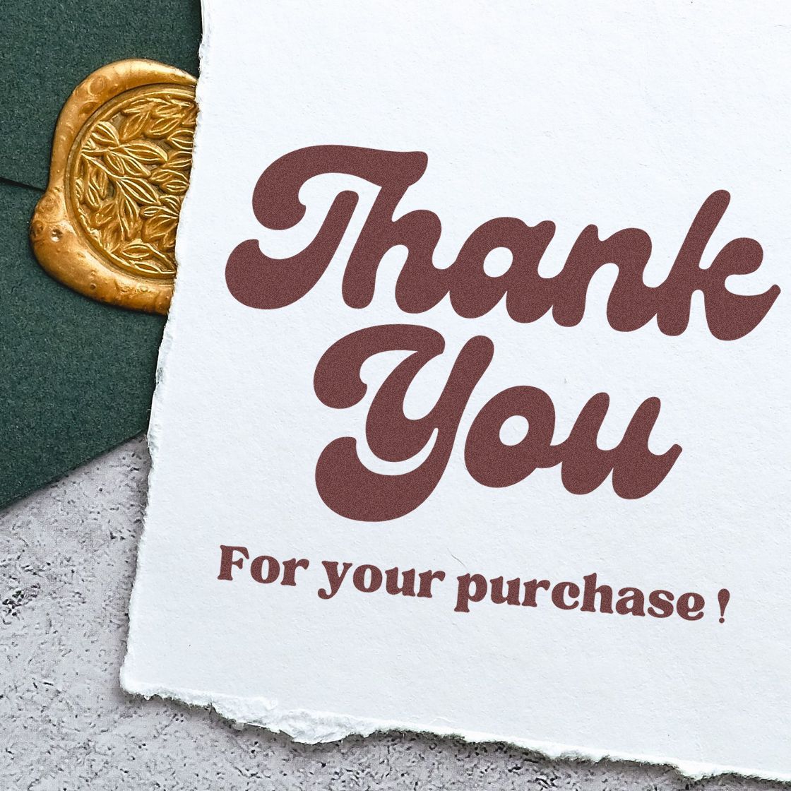 Brown Thank You stamp on textured white card with gold wax seal and dark green background.
