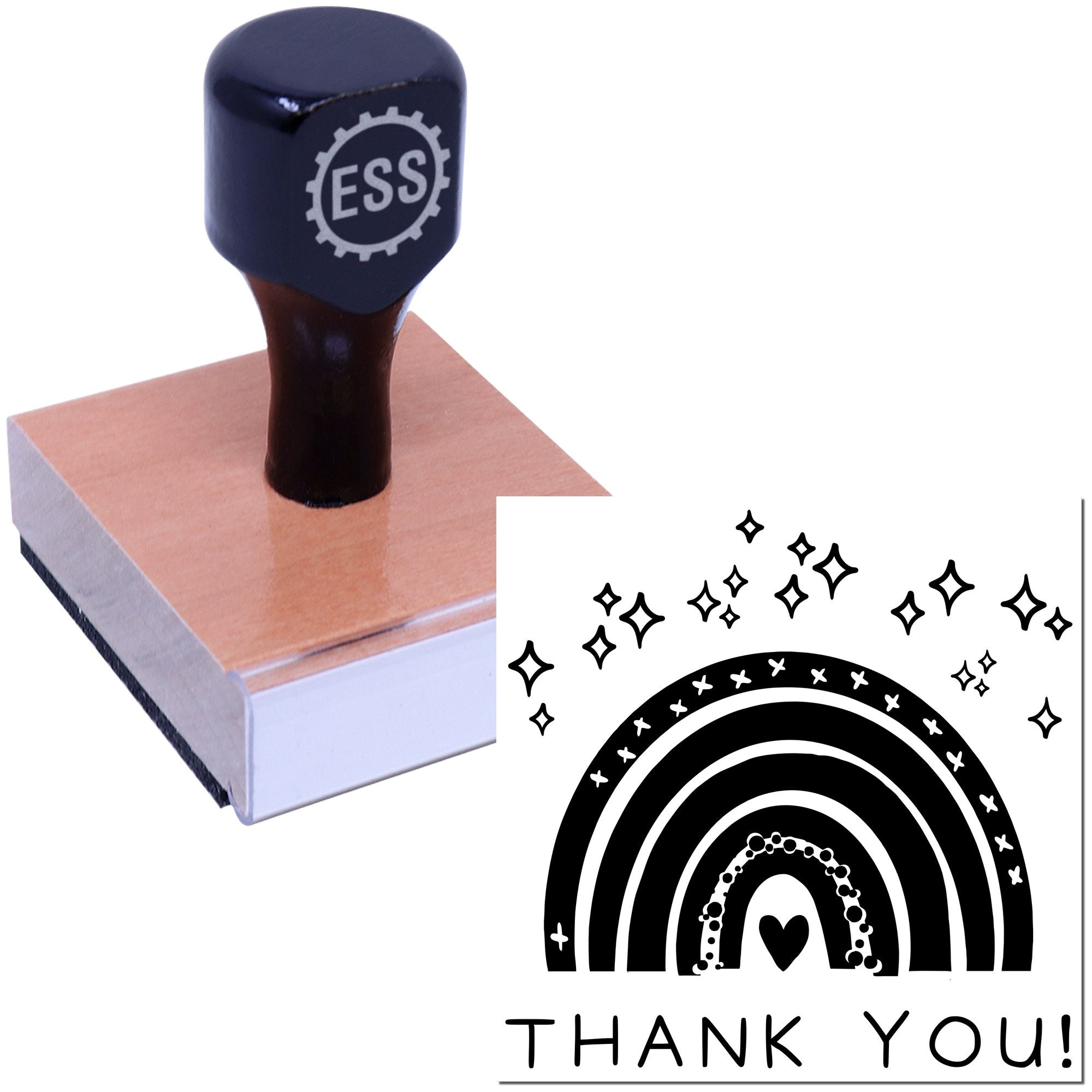 Black ESS stamp on wooden block beside rainbow thank-you seal with stars and heart in black and white.