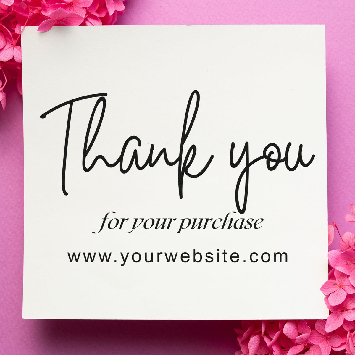 Black Thank you for your purchase stamp and seal on white card, framed by pink flowers on a pink background.