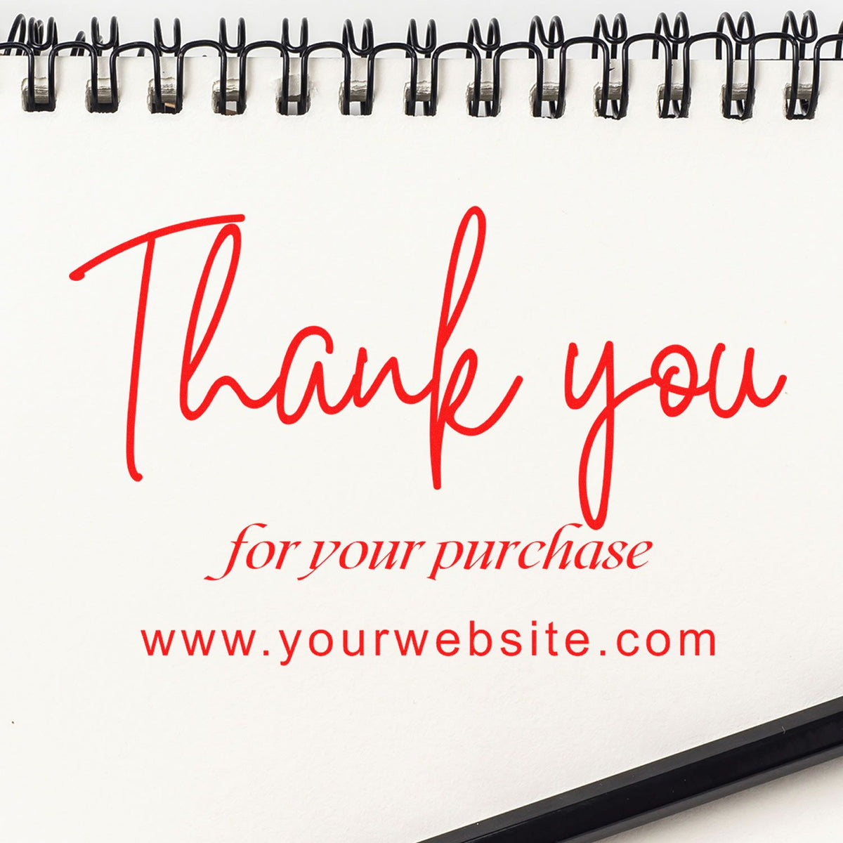 Custom stamp and seal thank-you card in red on a spiral-bound white notebook, with website and purchase message.