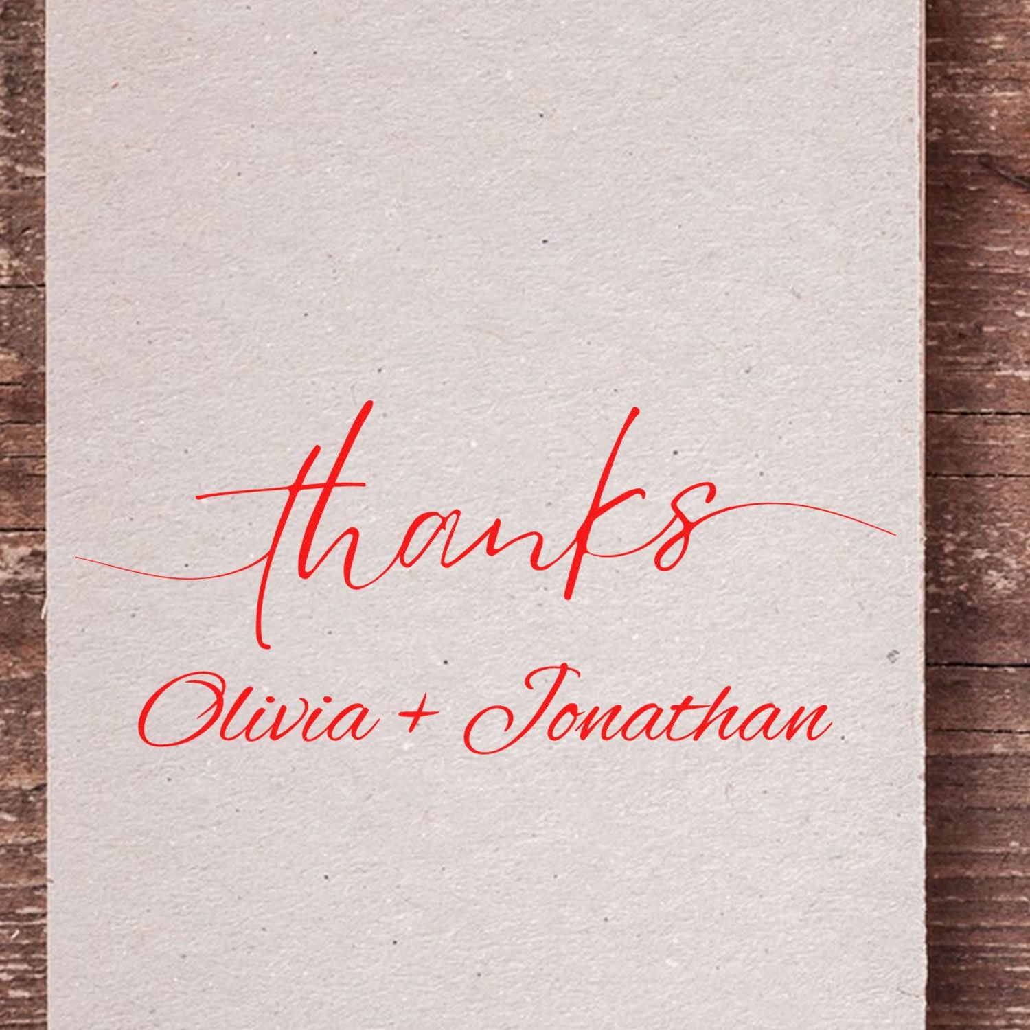 Custom red thank-you stamp seal reading thanks with Olivia + Jonathan on textured cream paper background.