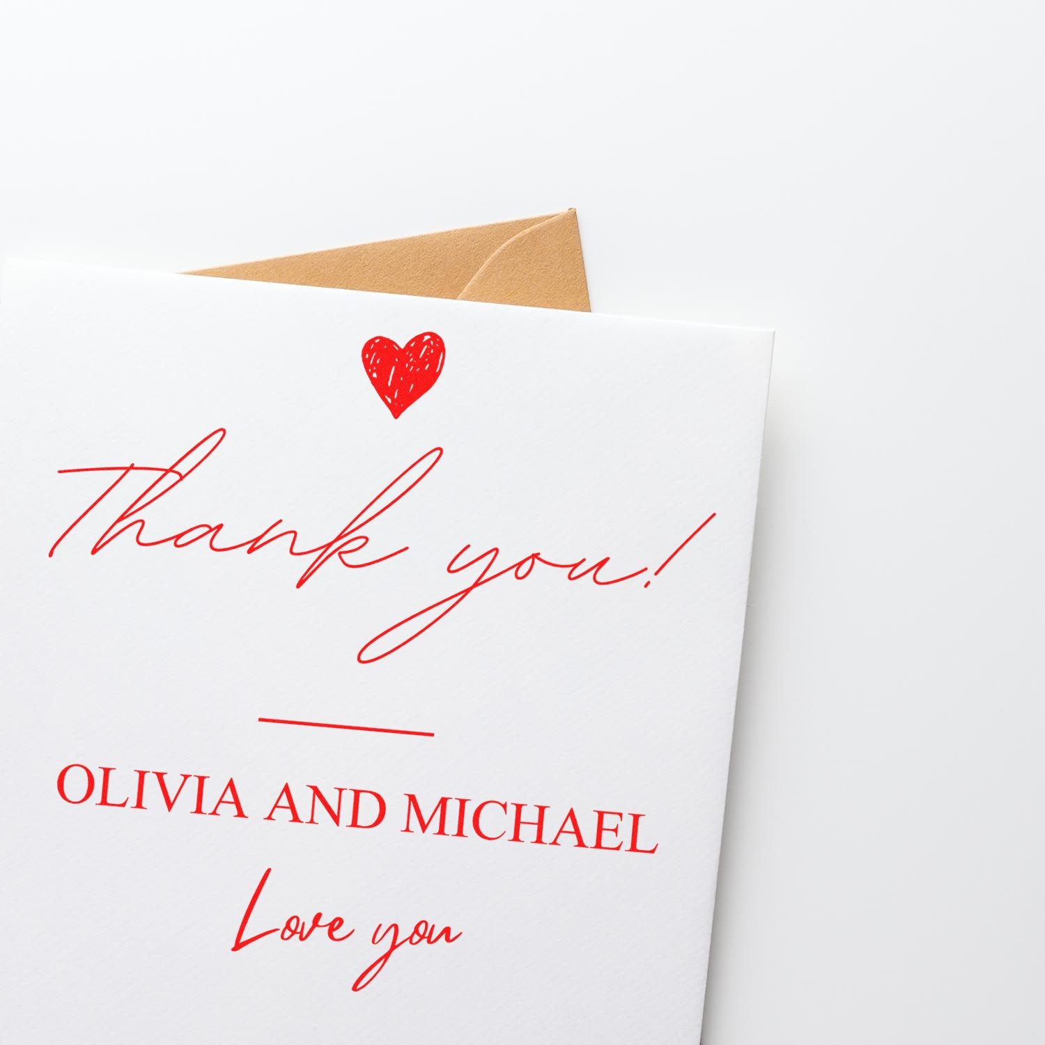 White thank-you card stamp and seal with red heart and red script, Olivia and Michael, tan envelope.