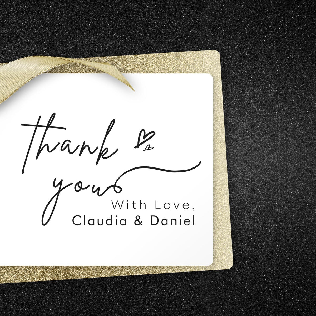 Gold ribboned square thank-you stamp and seal card with black script and hearts on black glitter background.
