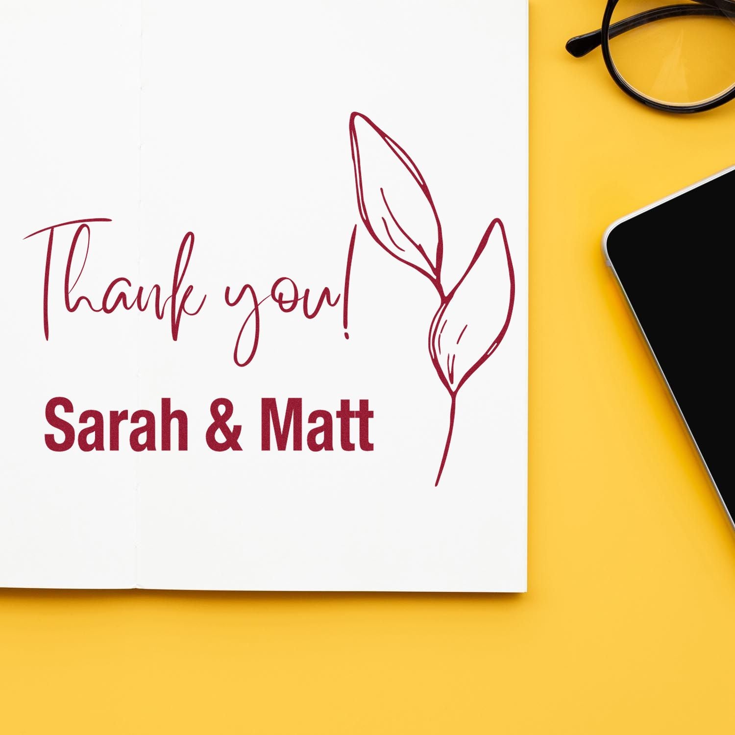 Burgundy custom stamp and seal with Thank you! and Sarah & Matt leaf design on a white card, on a bright yellow background.