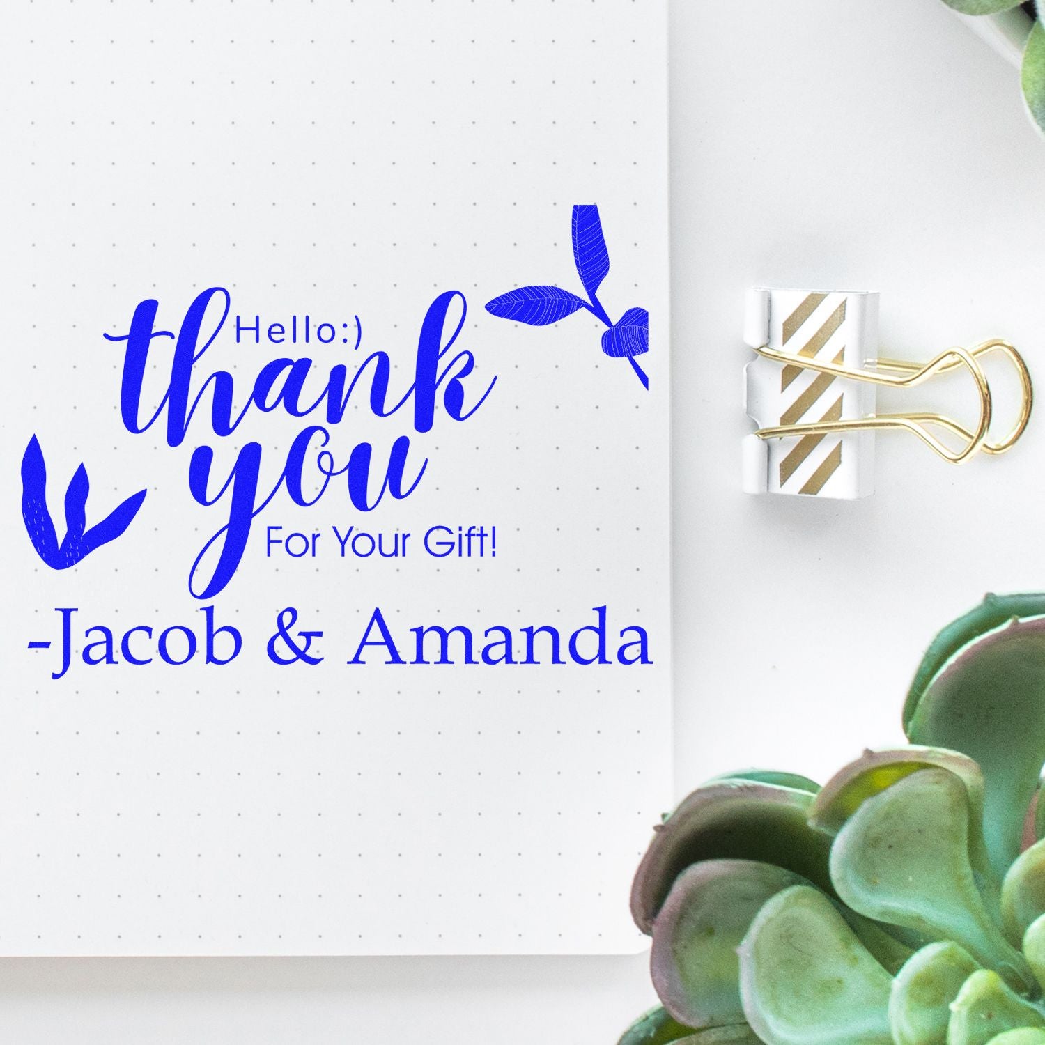 Blue personalized thank-you stamp and seal on white dotted paper, clipped with a gold-striped binder clip.