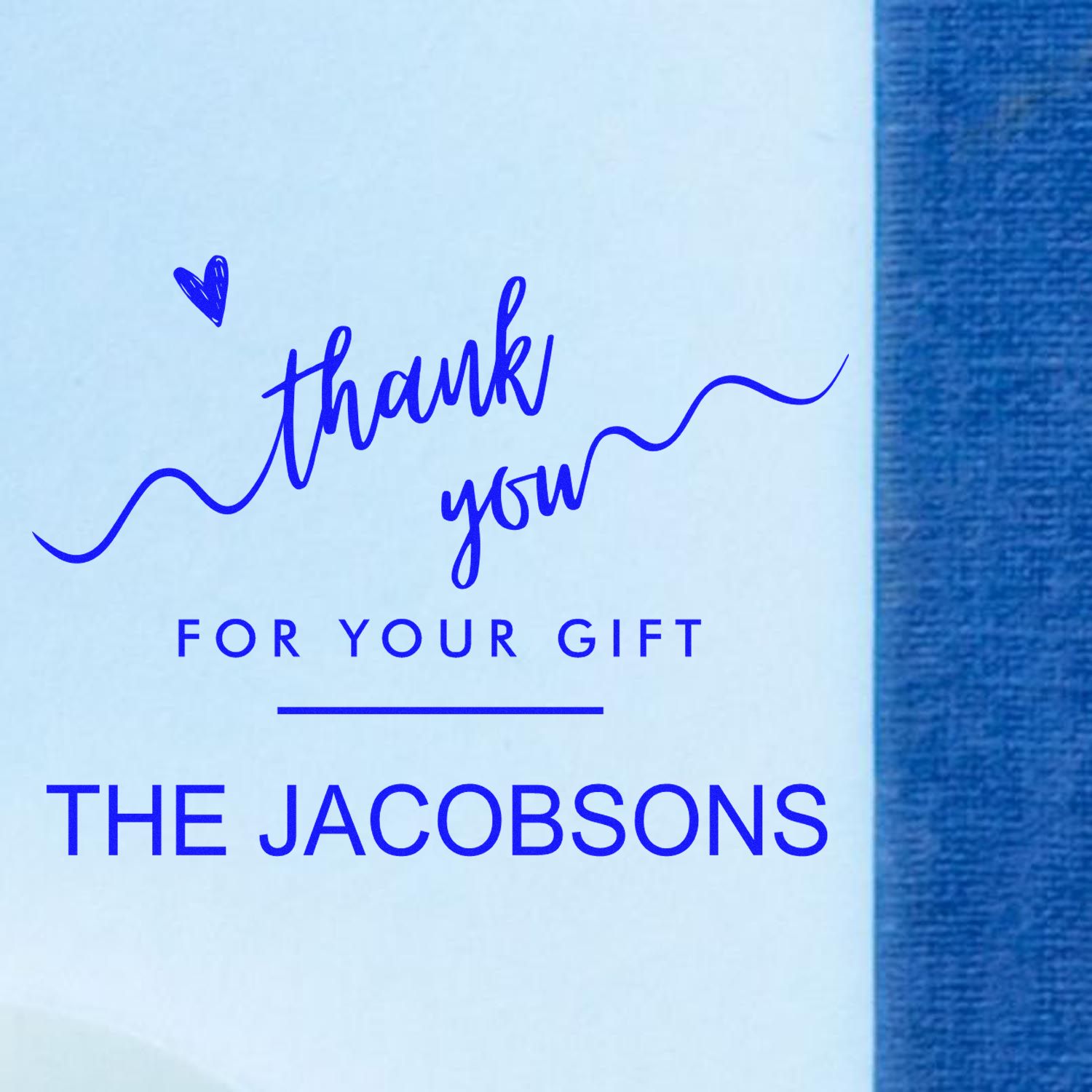 Blue thank-you stamp seal for a gift, with heart, cursive text, and THE JACOBSONS on a white background.