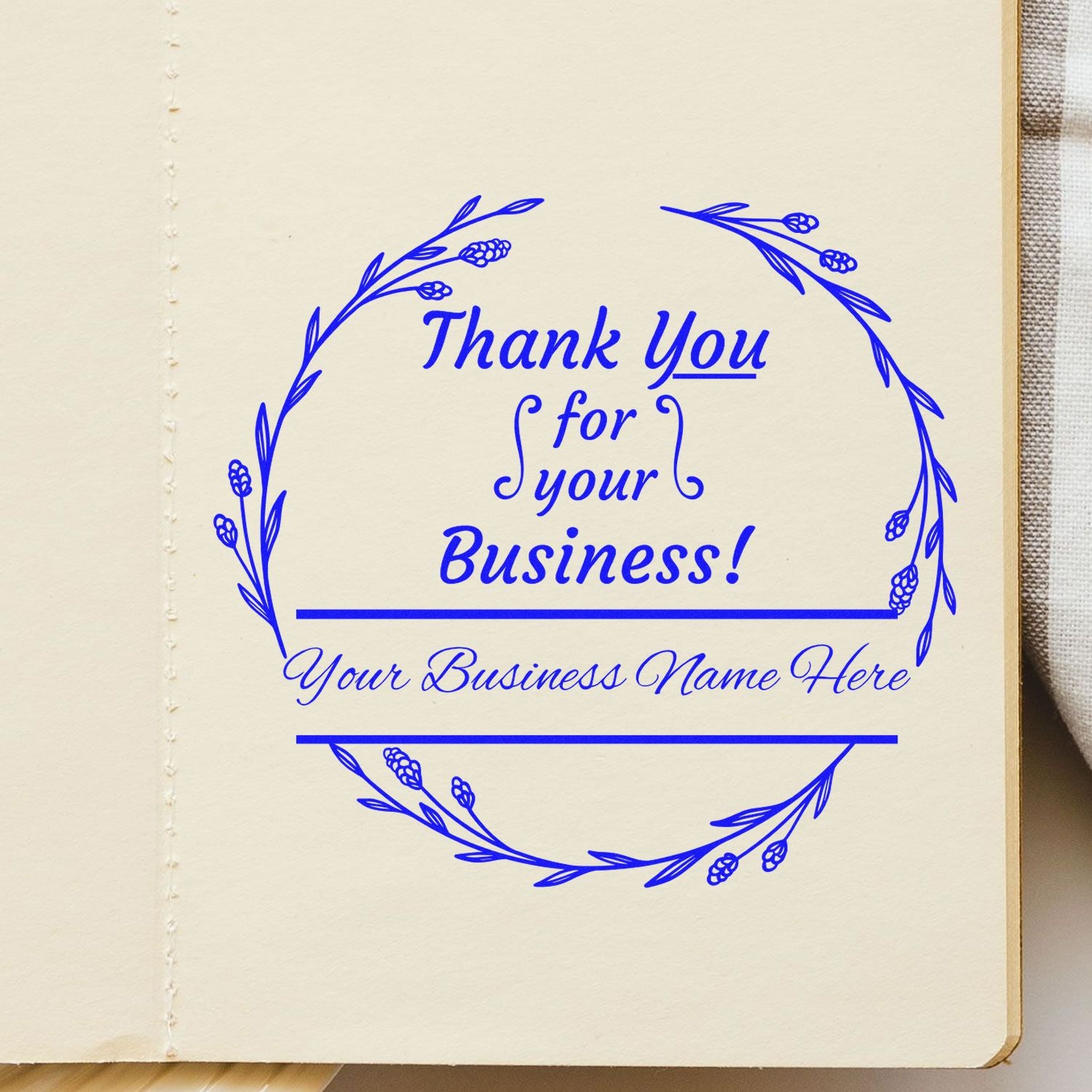 Blue custom thank you for your business stamp and seal with floral wreath on cream paper