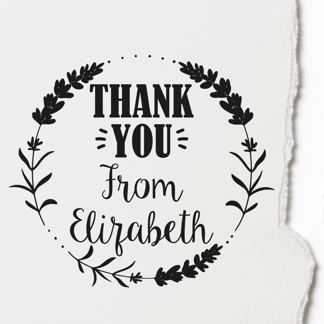 Black decorative thank-you stamp seal with leafy wreath and From Elizabeth on white paper.