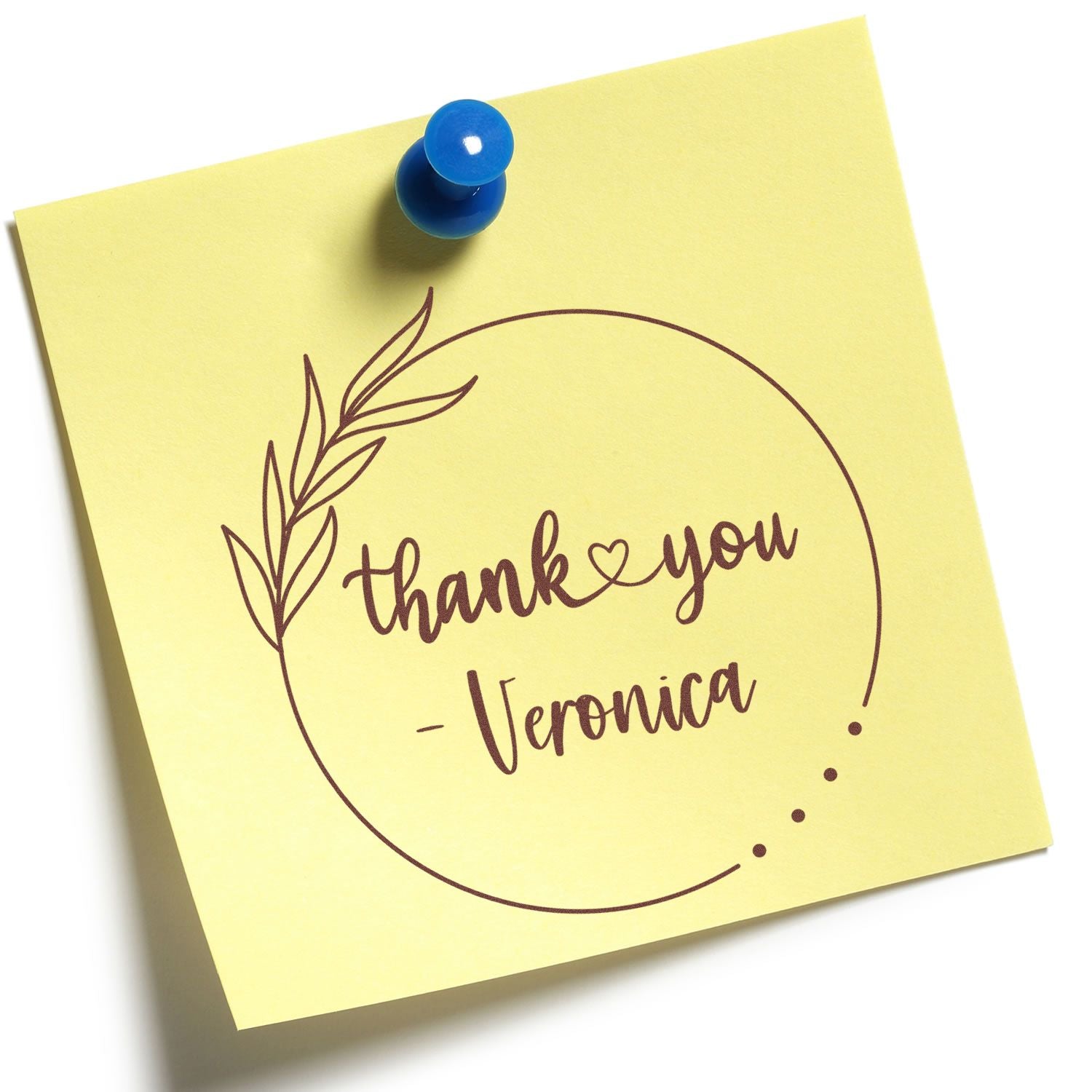 Yellow thank-you stamp seal with brown script, leaf wreath, and blue pushpin