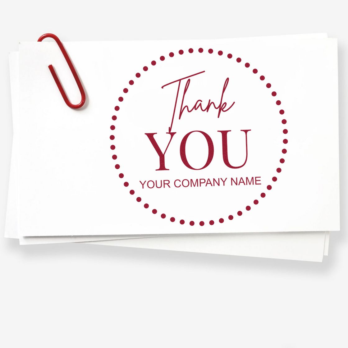 Custom red thank-you stamp seal with dotted circle and company name on white cards, clipped with a red paperclip.