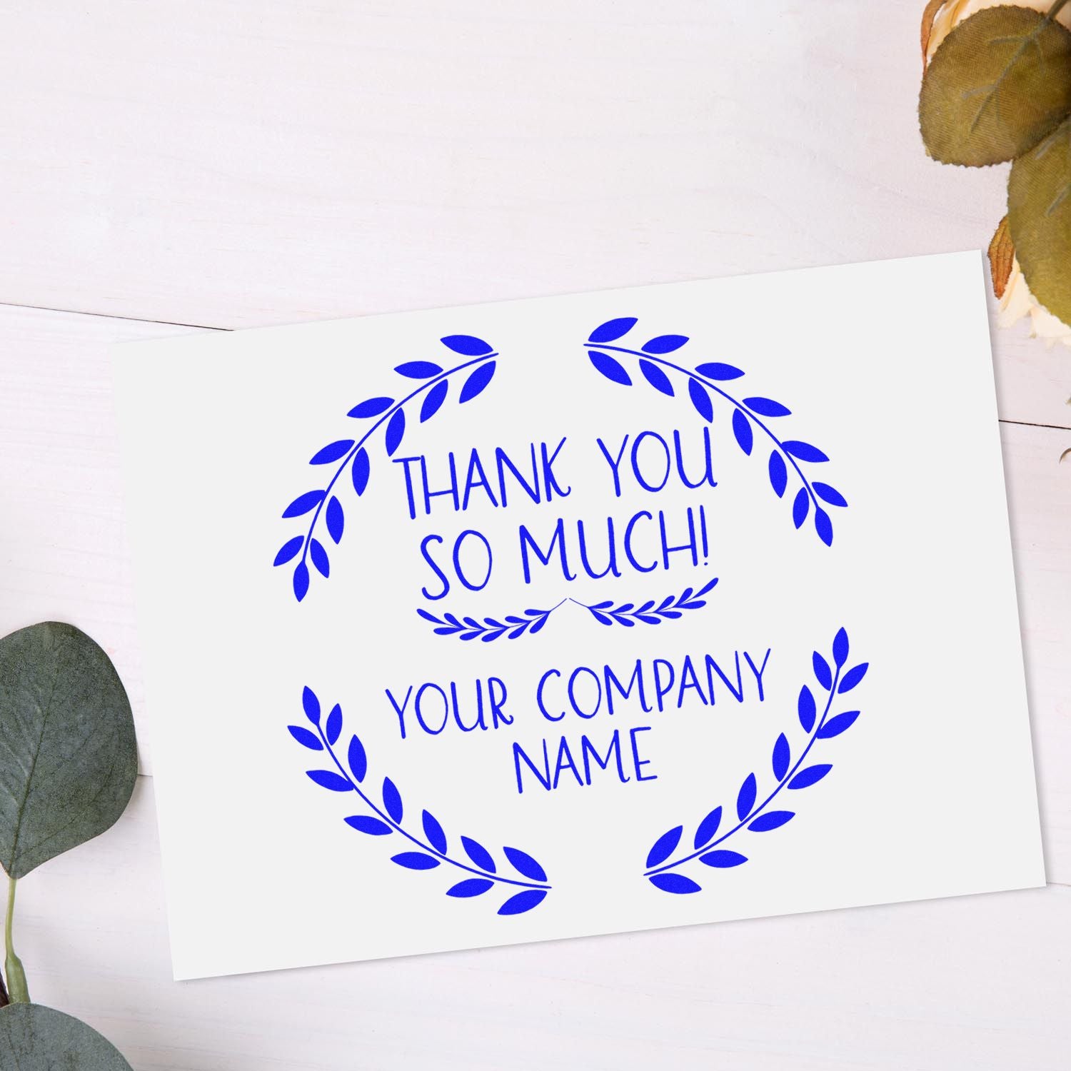 Blue leafy thank-you stamp and seal design with Thank You So Much! and Your Company Name on a white card.
