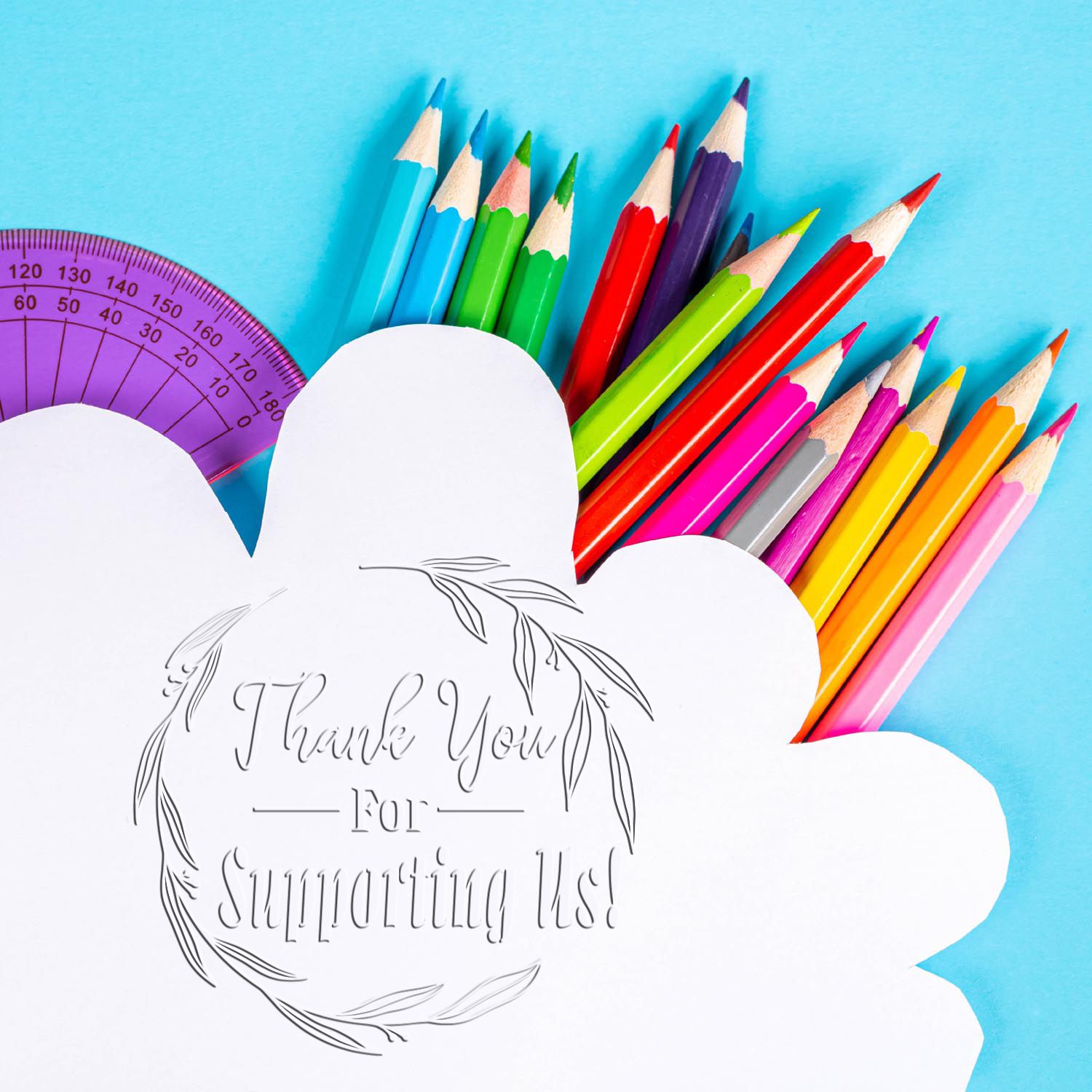 Colorful pencils and a purple protractor behind white stamp and seal labels reading Thank You For Supporting Us!