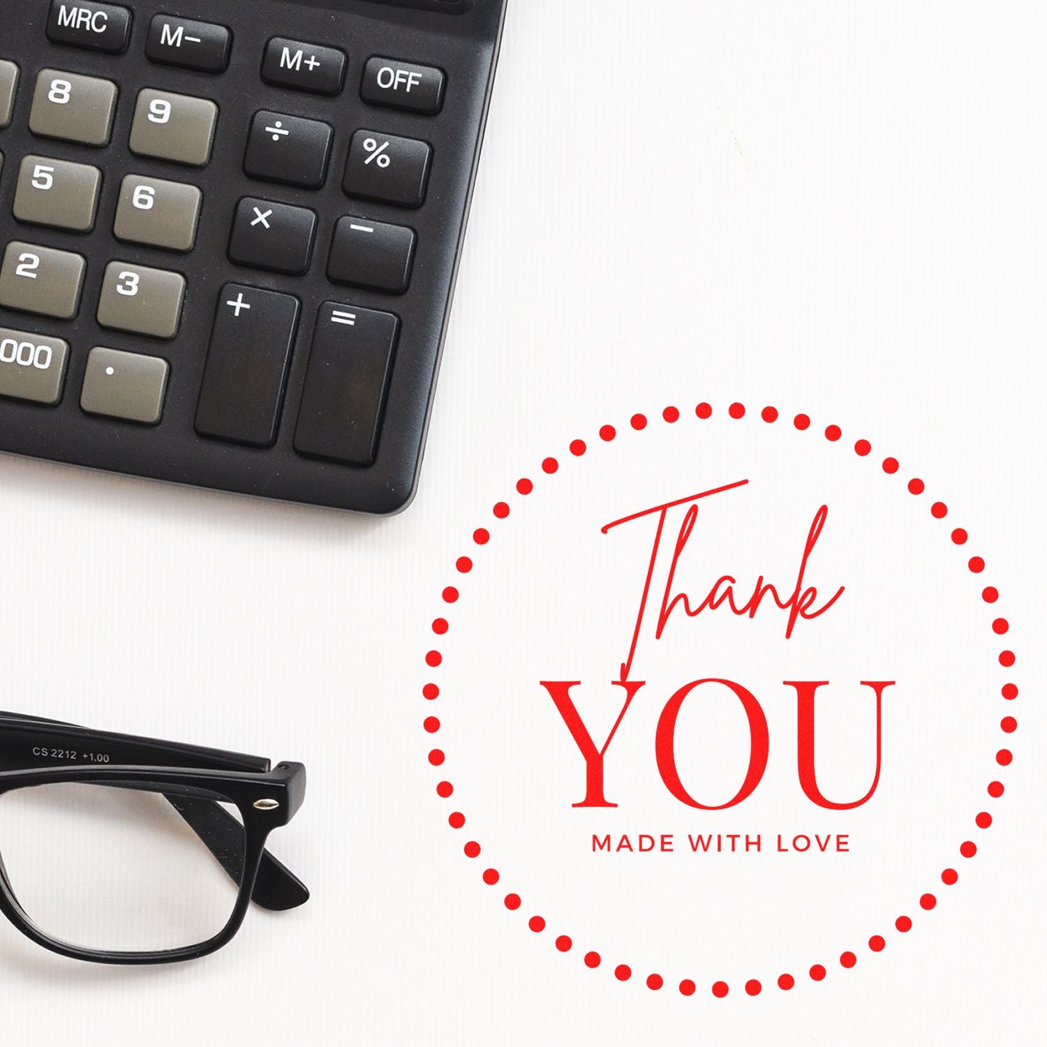Red thank-you stamp seal with dotted circle and Made with Love, beside black calculator and eyeglasses on white.