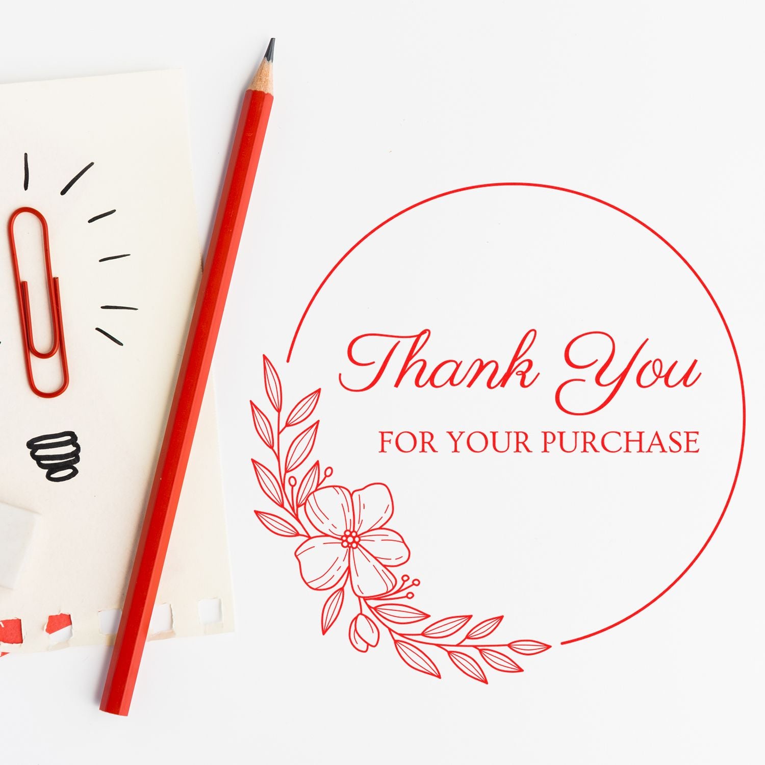 Red thank-you purchase stamp seal with floral border, shown beside a red pencil and paper clips on white background.
