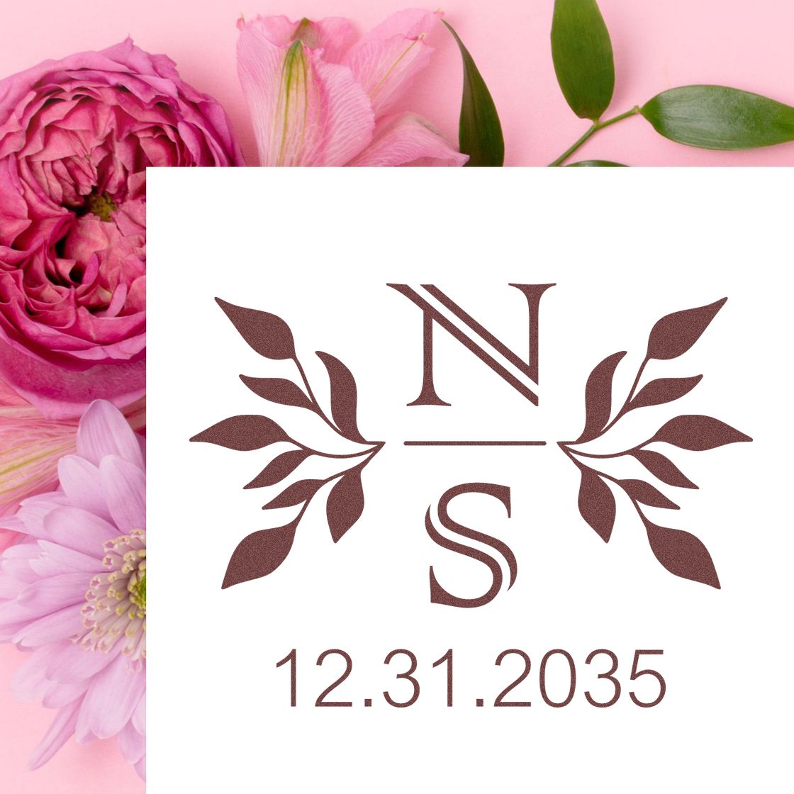 Rose-gold N and S wedding stamp seal with leafy wreath, 12.31.2035, on a pink floral background.