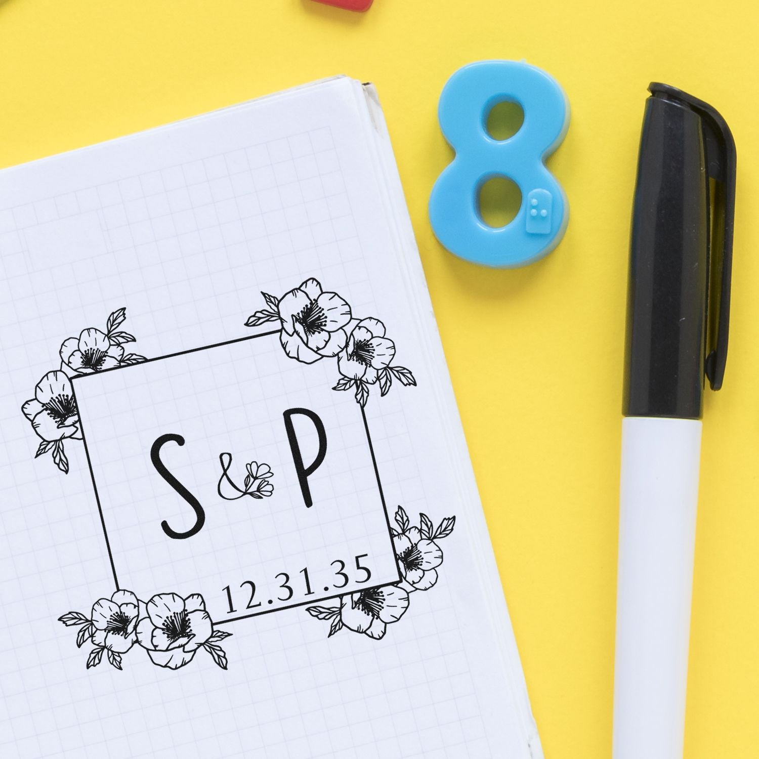 Floral S&P stamp and seal design on grid paper, with a blue number 8 seal and black pen on bright yellow background.