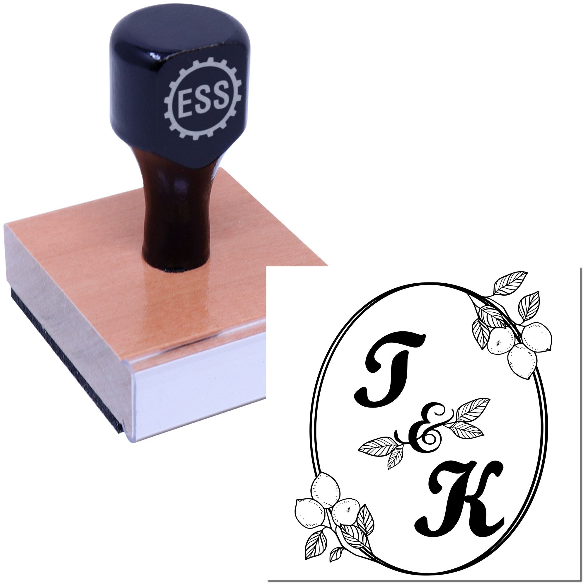 Black ESS rubber stamp on a wooden block beside a floral FK seal design with leaves and fruit.