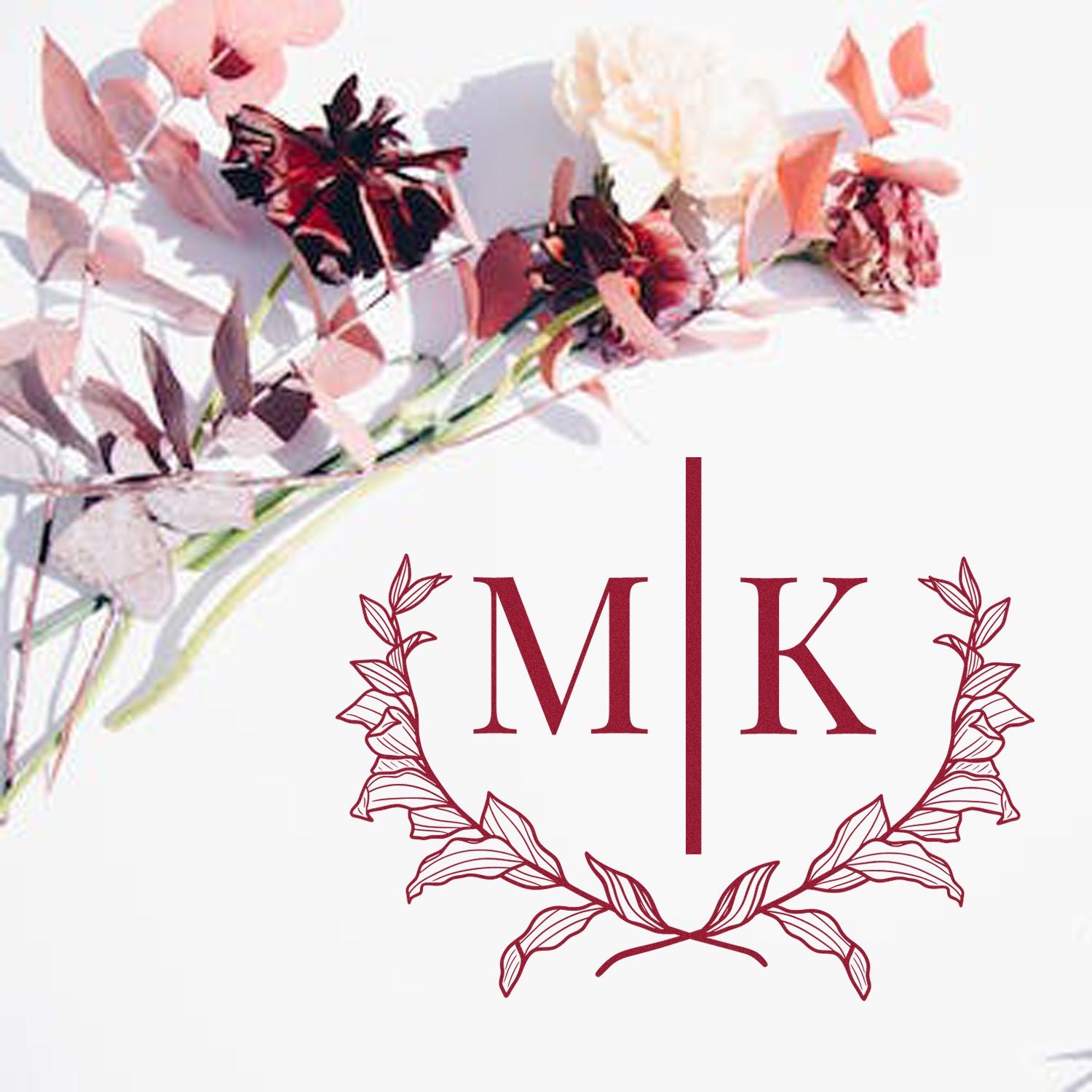 Burgundy M|K custom stamp seal with leafy wreath and pink floral accents on white background