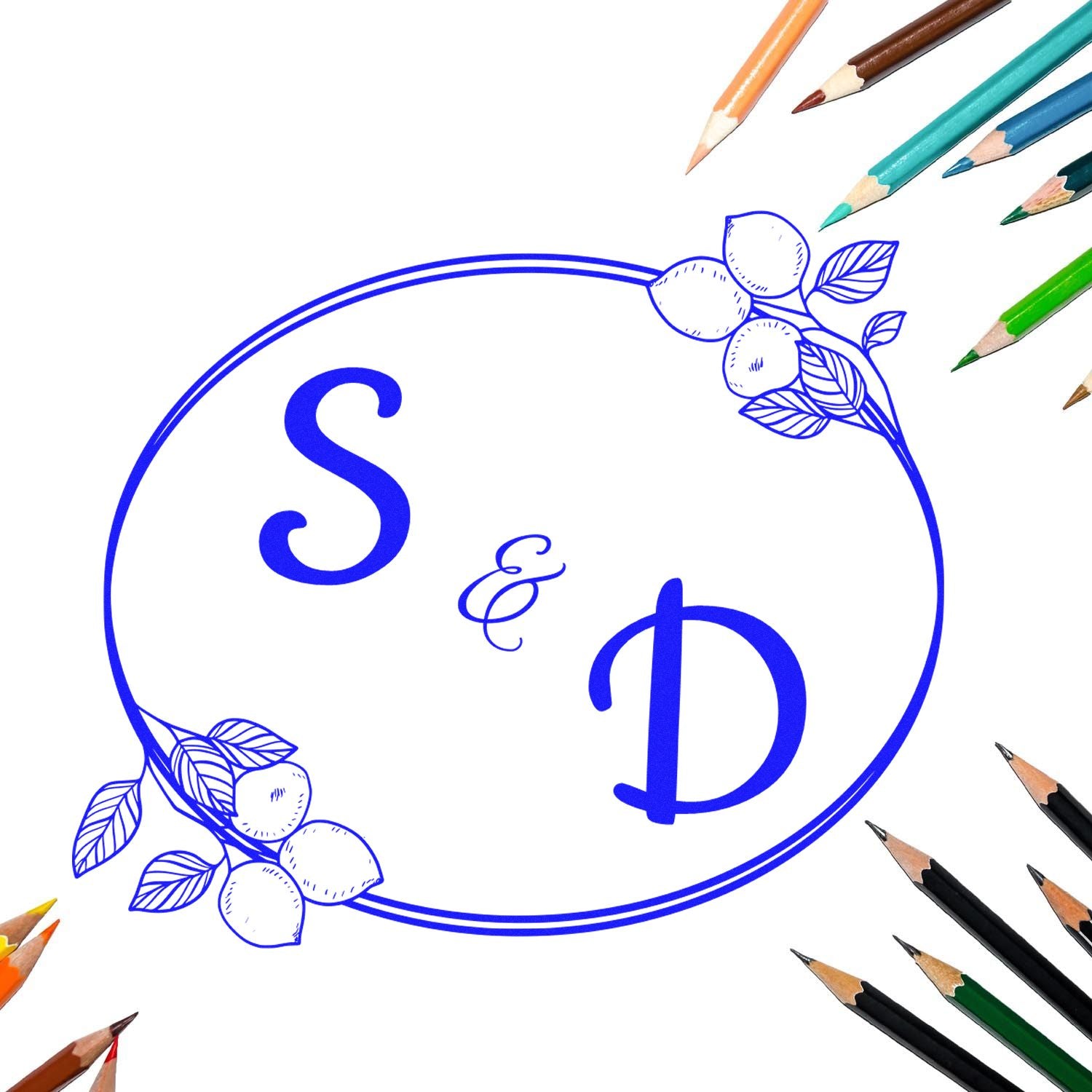 Blue S&D monogram stamp seal with floral lemon accents, surrounded by colored pencils on a white background.