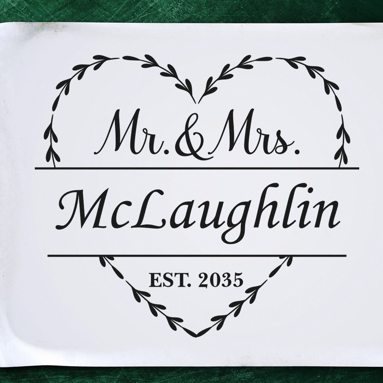 Black wedding stamp and seal with leaf heart wreath, Mr. & Mrs. McLaughlin and EST. 2035 in black on white paper.