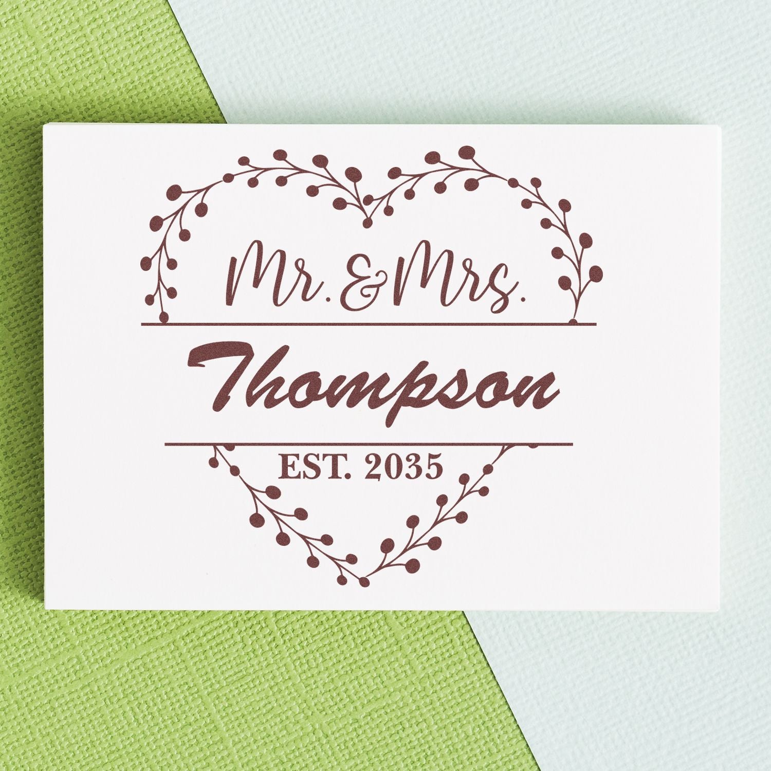 Maroon Mr. & Mrs. Thompson custom stamp seal with heart wreath and EST. 2035 on white card