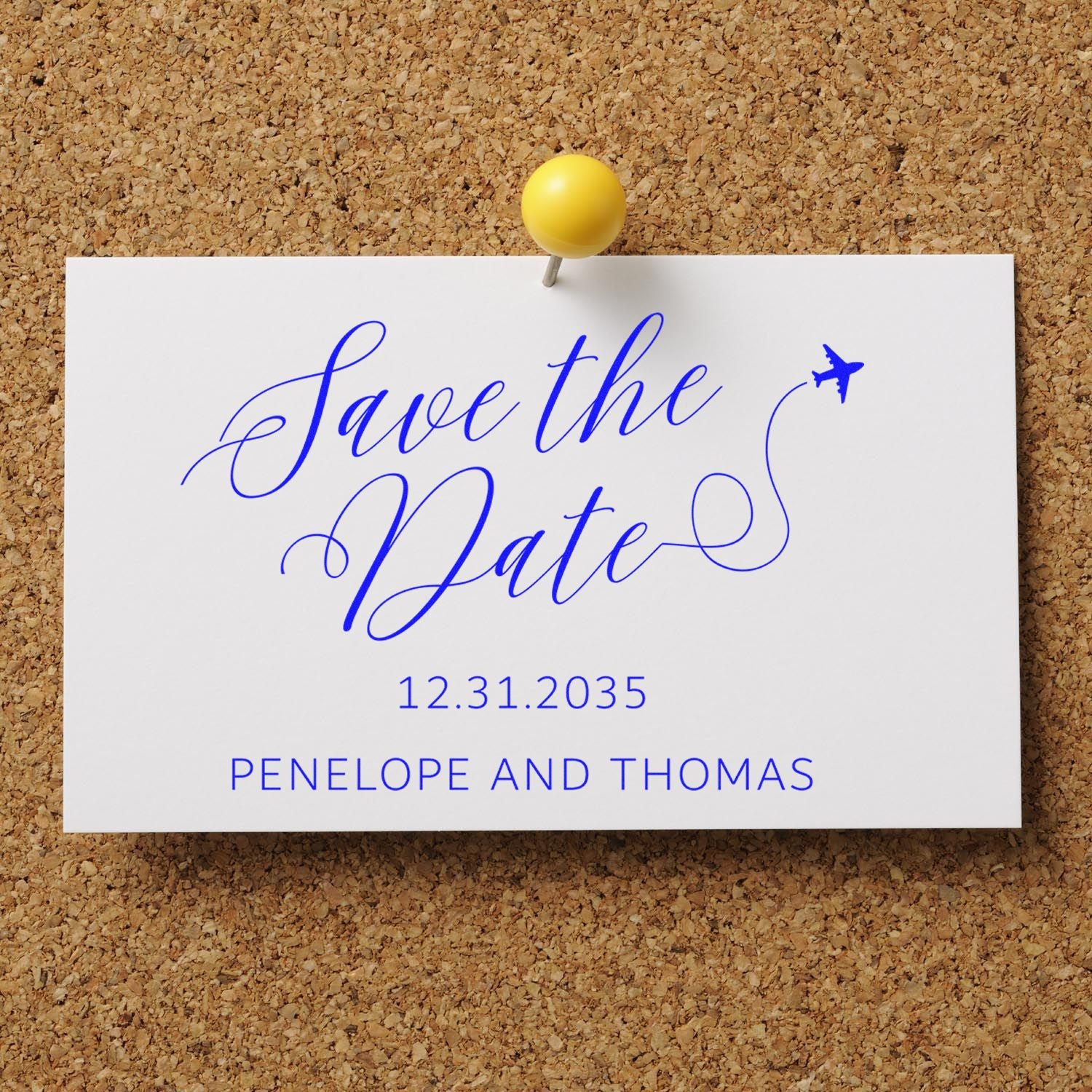 Blue save-the-date stamp and seal on white card, pinned to corkboard with yellow pushpin, plane motif, date 12.31.2035.