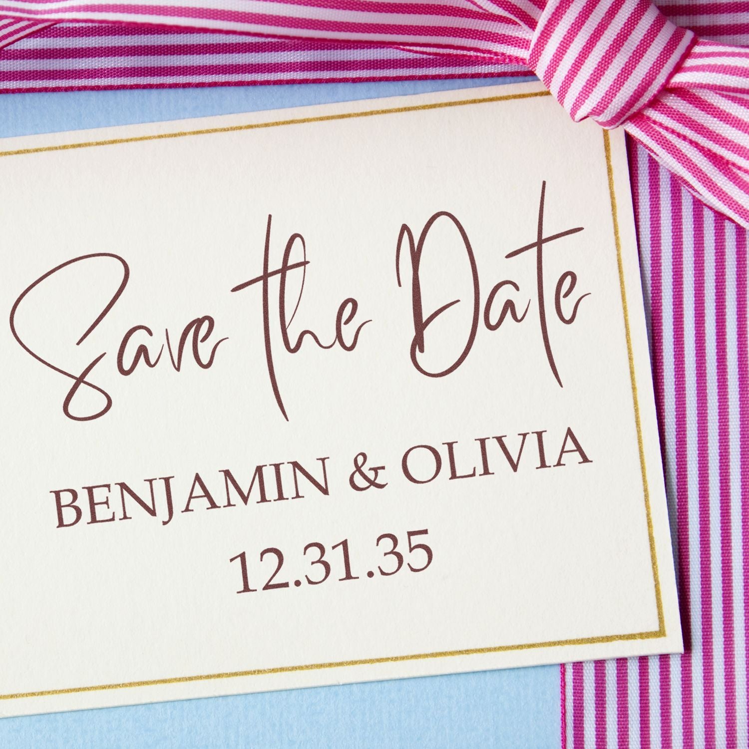 Wedding save-the-date stamp and seal card with pink striped ribbon, gold border, and burgundy text for Benjamin & Olivia, 12.31.35.