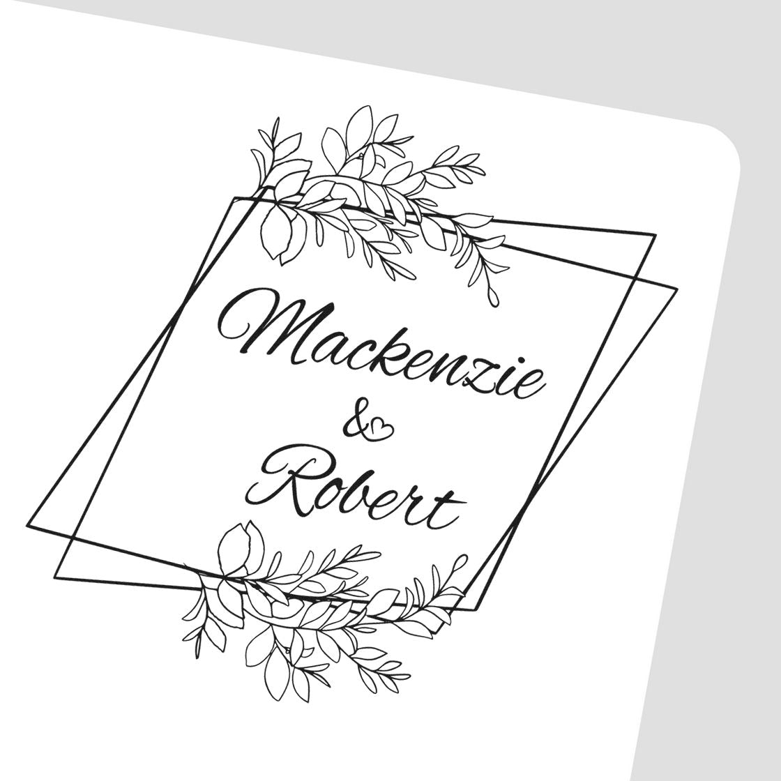 Black wedding monogram stamp seal with leafy floral frame and names Mackenzie & Robert on white background.