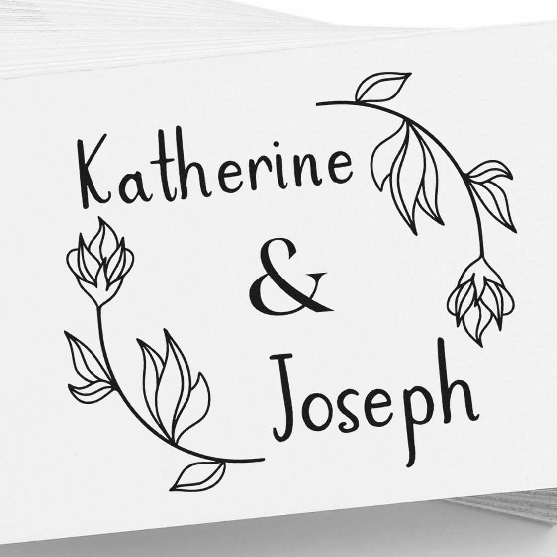 Custom black wedding stamp seal with Katherine & Joseph, framed by delicate floral leaf wreaths on a white background