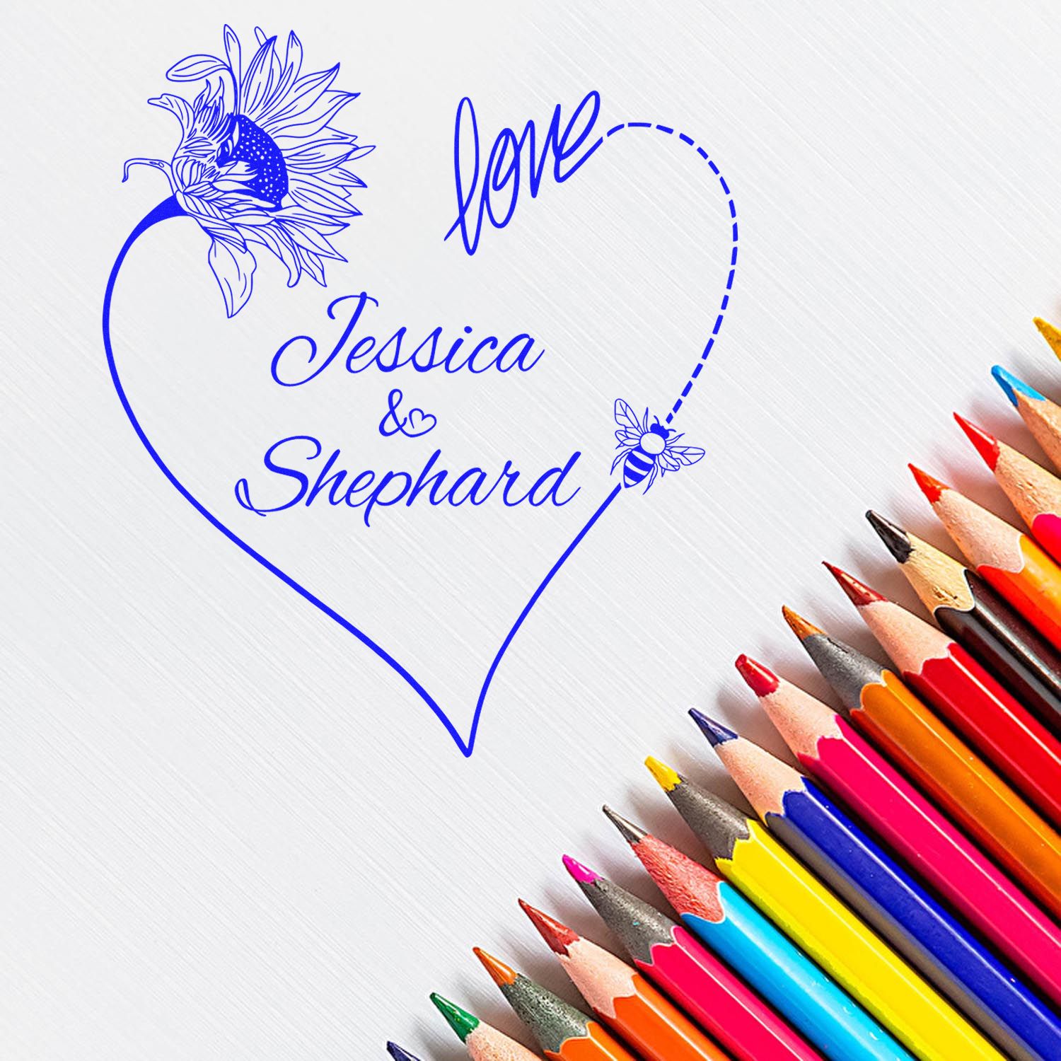 Blue heart-shaped custom stamp seal with sunflower, bee and love Jessica & Shepard, beside colorful pencils.