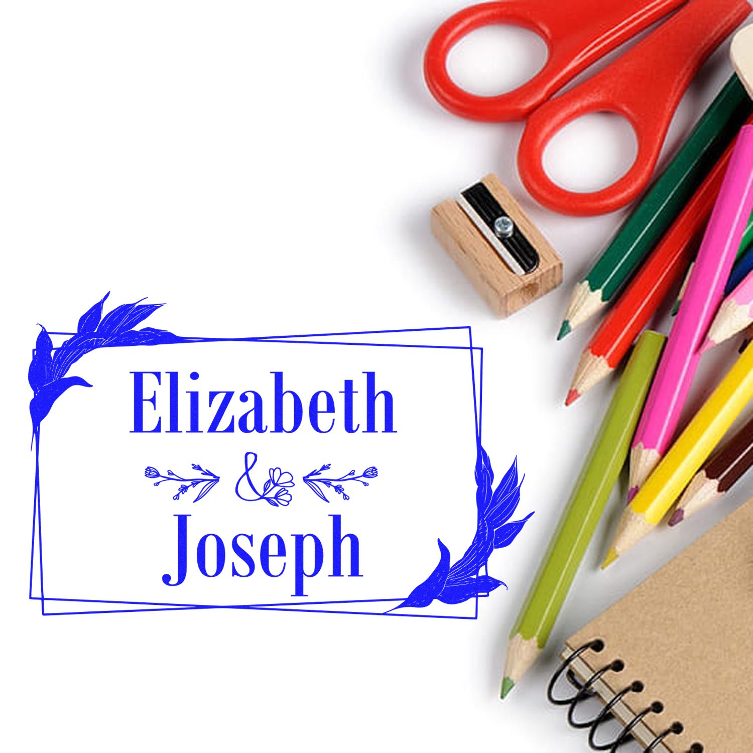 Blue personalized stamp seal reading Elizabeth Joseph, with red scissors, colored pencils, and a wooden stamp.