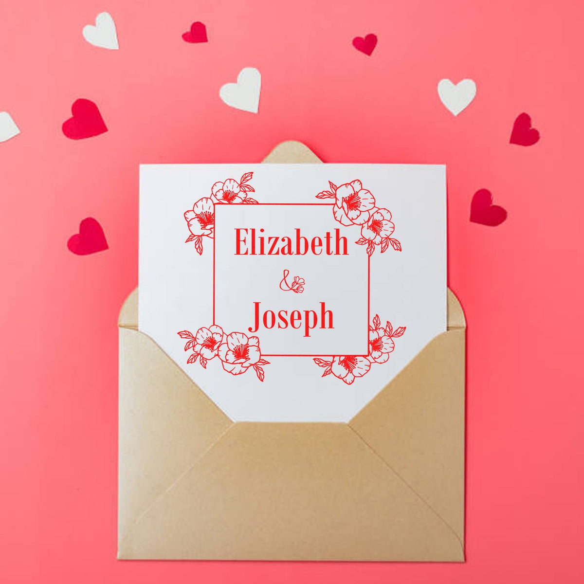 Personalized red floral stamp seal on white card in tan envelope, with Elizabeth and Joseph, on pink background with heart confetti