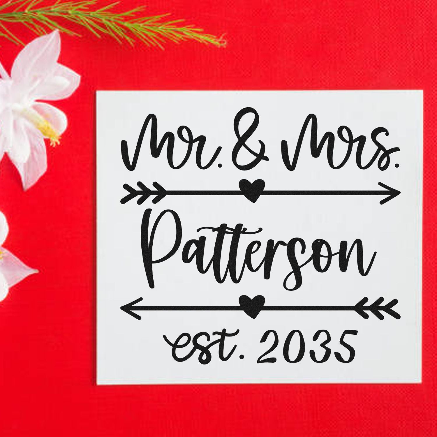 Custom wedding stamp seal with black Mr. & Mrs. Patterson est. 2035 script on white square, red background and hearts