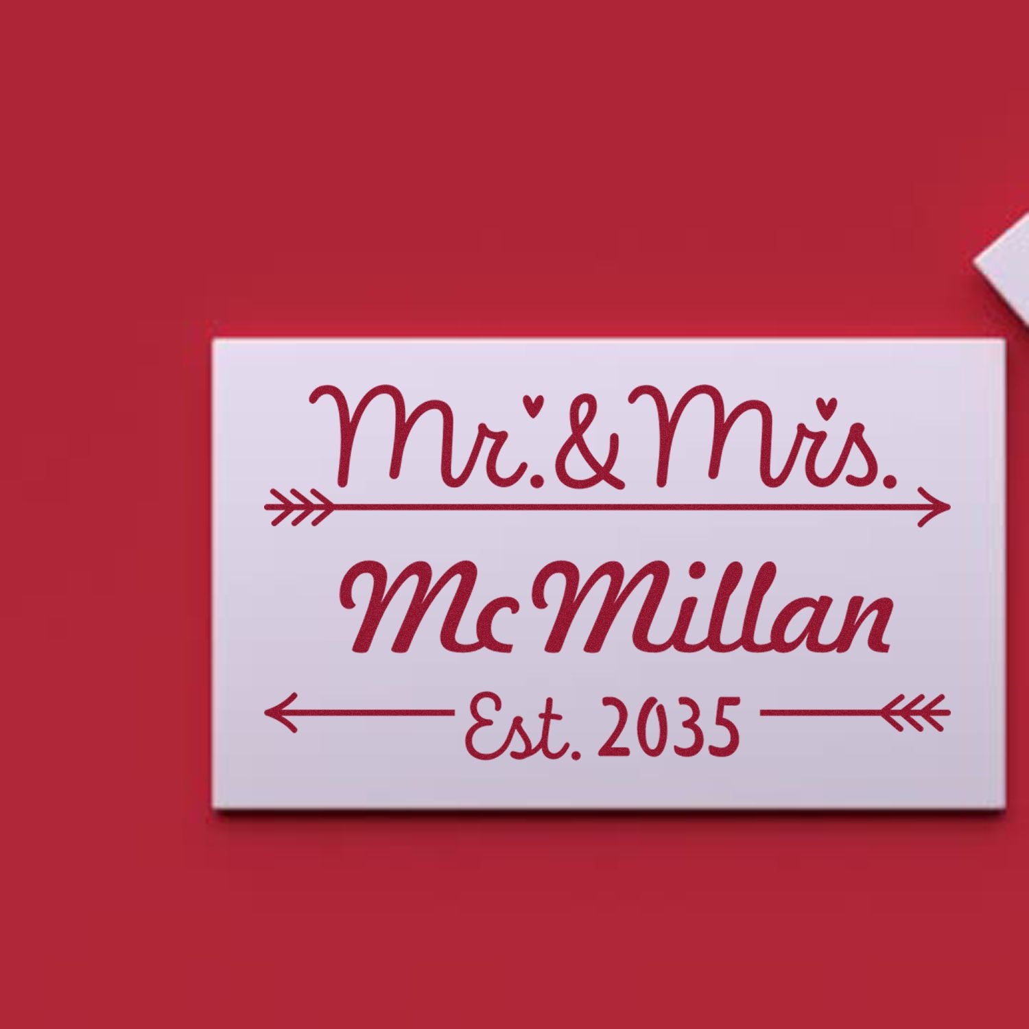 Red custom stamp and seal on white backing, with burgundy script reading Mr. & Mrs. McMillan Est. 2035 and arrow accents.