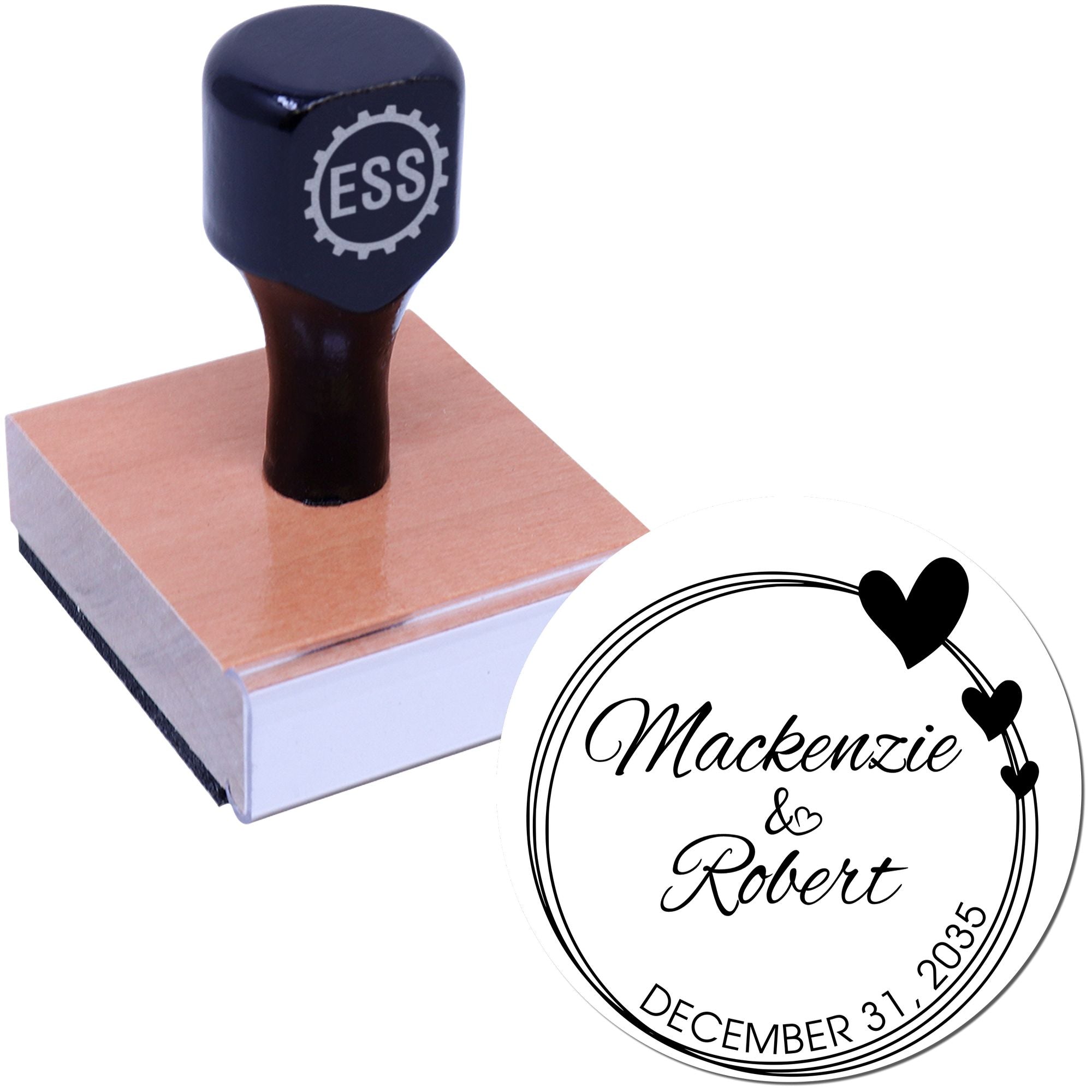 Black custom rubber stamp on a brown wooden block, with circular white wedding seal featuring hearts, Mackenzie & Robert, December 31, 2035.